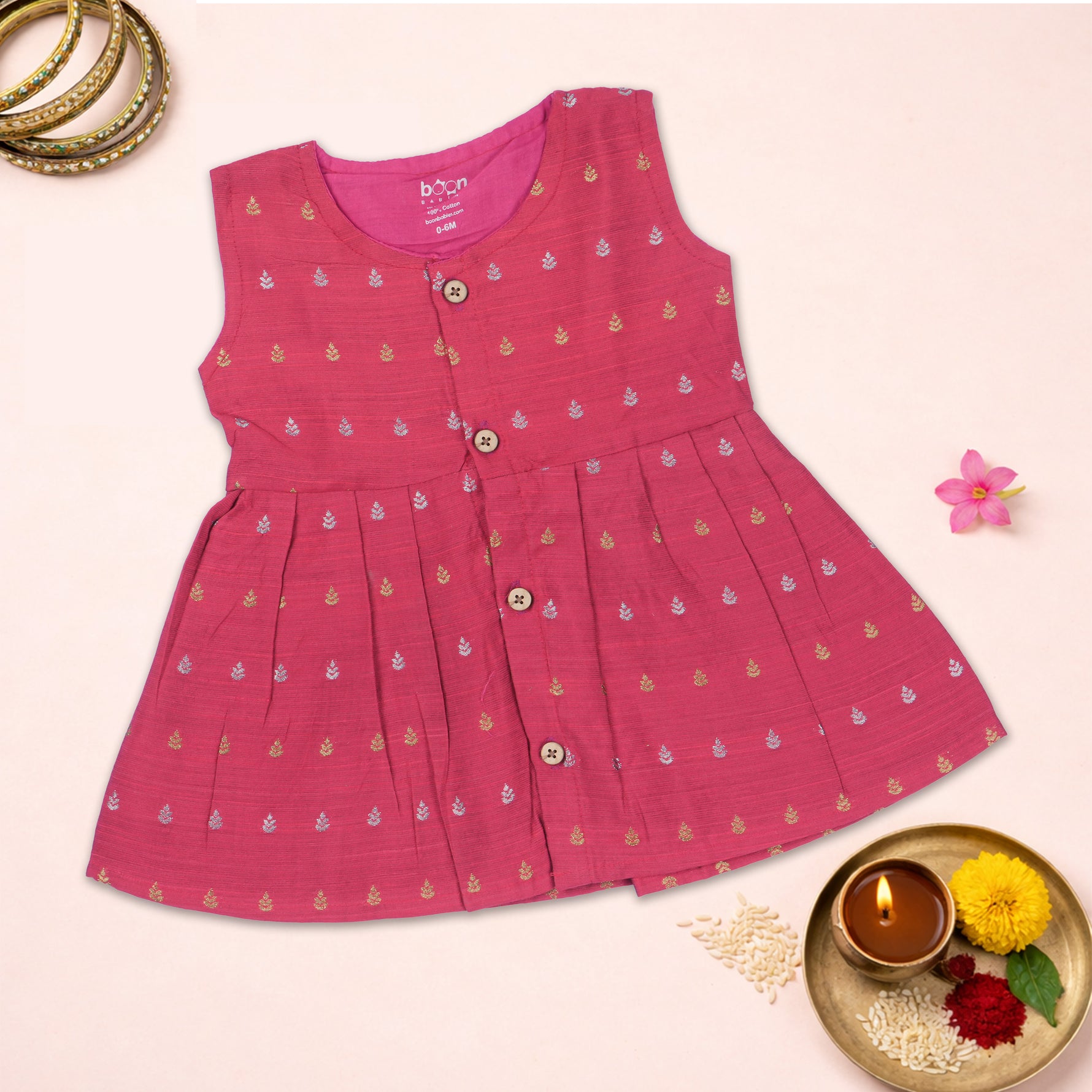 Baby girl wearing a pink ethnic sleeveless frock by Boon Babies, featuring traditional embroidery and a comfortable fit.
