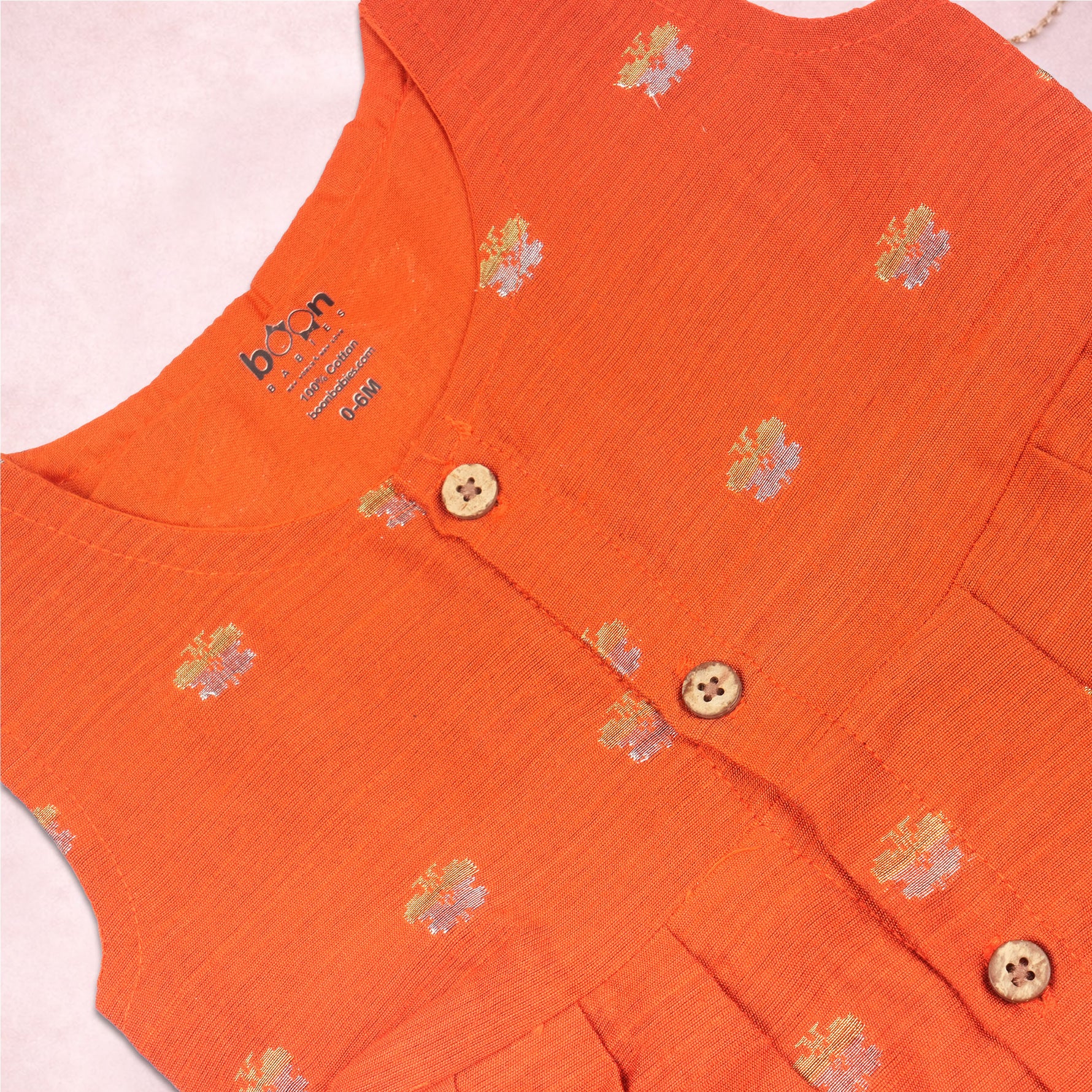 Orange ethnic sleeveless frock for baby girls by Boon Babies, featuring traditional design and comfortable fabric.