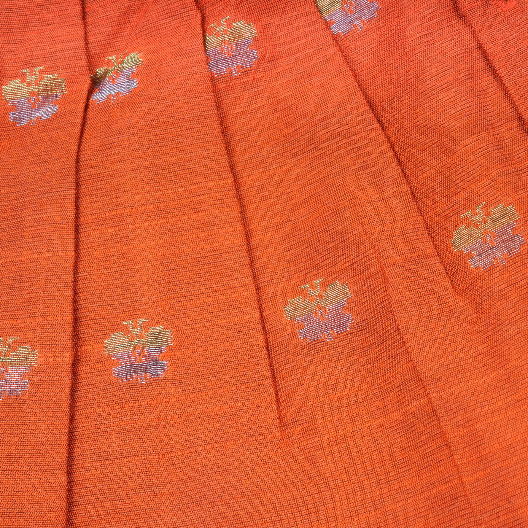 Baby girl wearing a bright orange ethnic sleeveless frock by Boon Babies, featuring traditional embroidery and comfortable fabric.