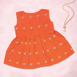 Orange ethnic sleeveless frock for baby girls by Boon Babies, featuring embroidered details and a comfortable fit.