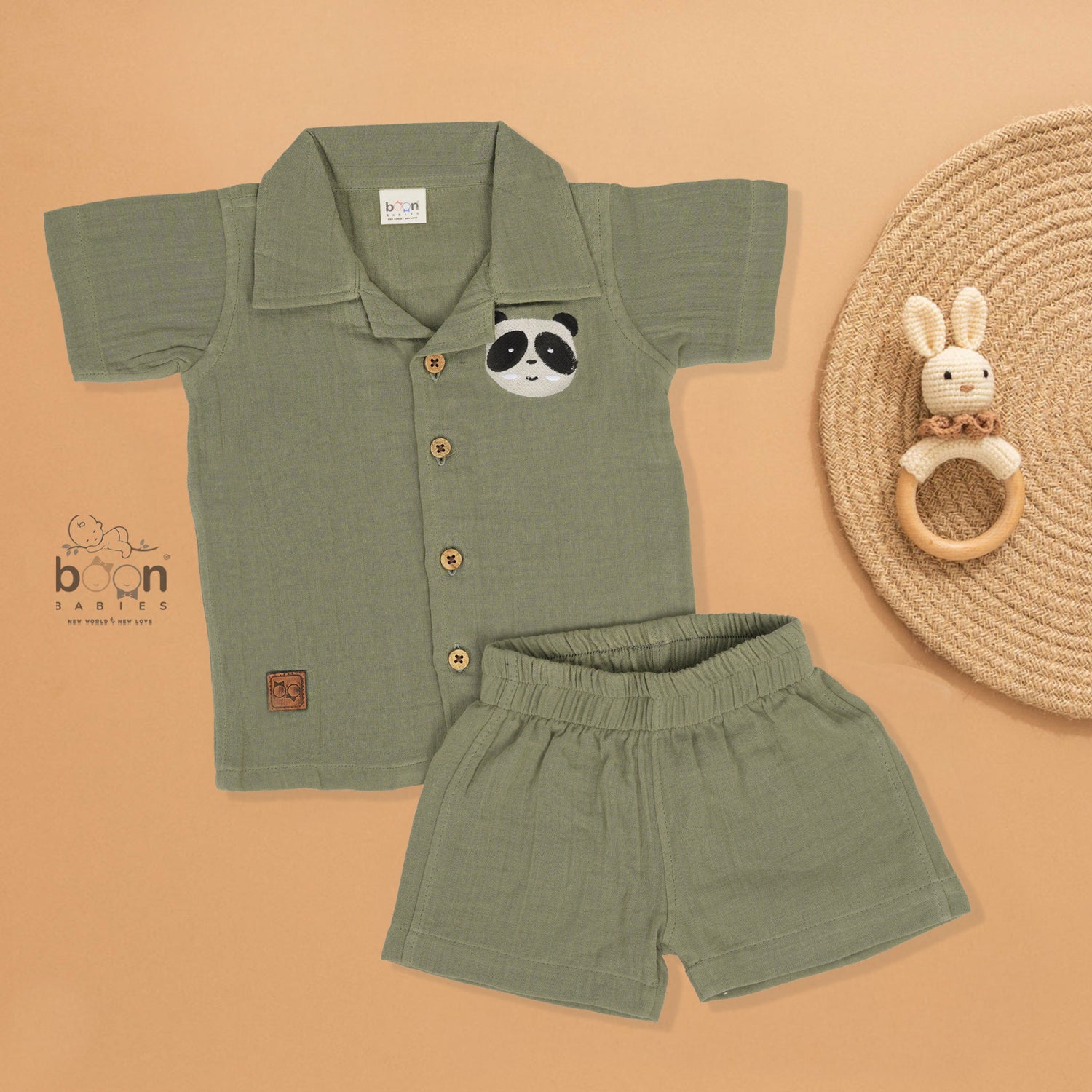Panda face embroidered crinkle muslin shirt and shorts set in earthy green for boys, featuring an open collar and elastic shorts – from Boon Babies, Coimbatore.
