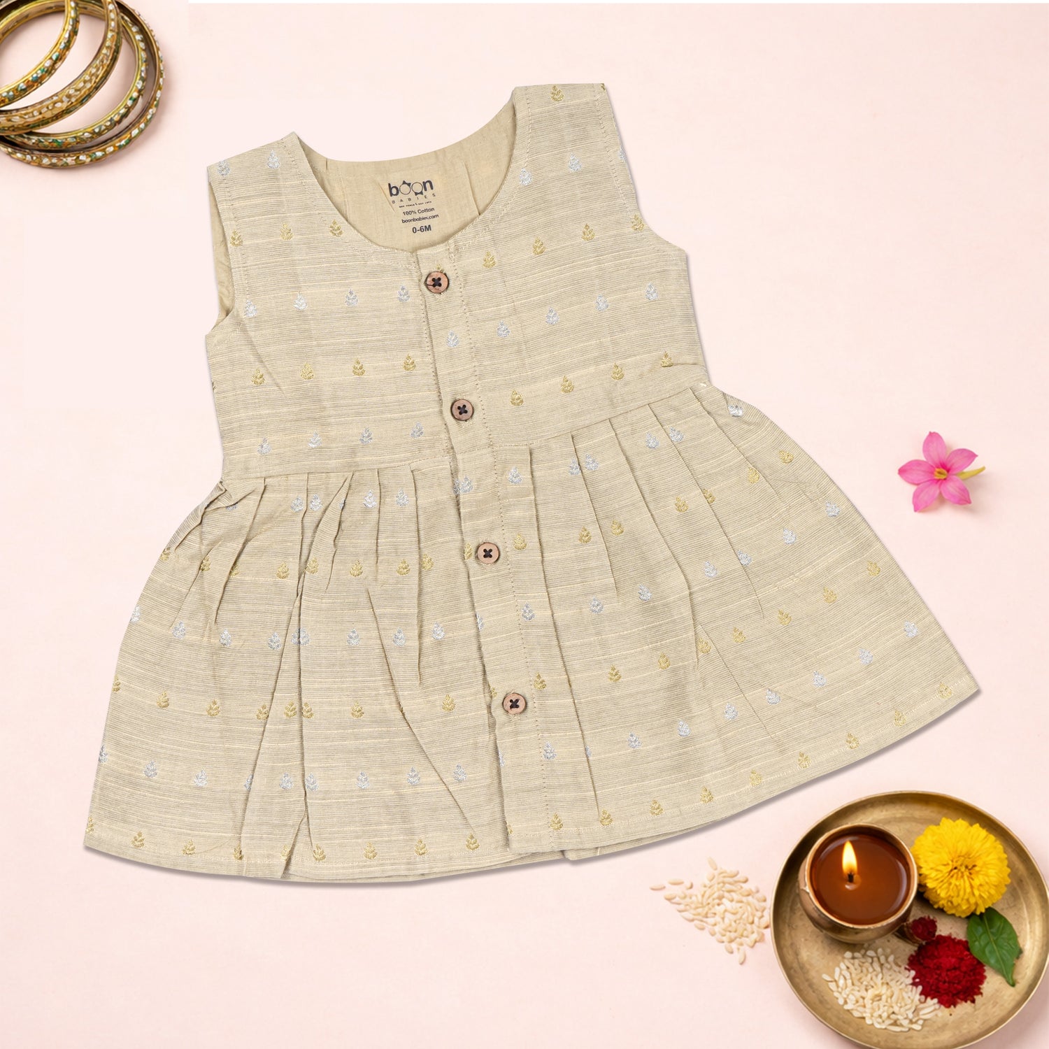 Baby girl wearing a premium ivory ethnic sleeveless frock by Boon Babies, showcasing the detailed embroidery and elegant design.