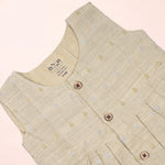 Baby girl wearing a premium ivory ethnic sleeveless frock by Boon Babies, featuring traditional design and soft fabric.
