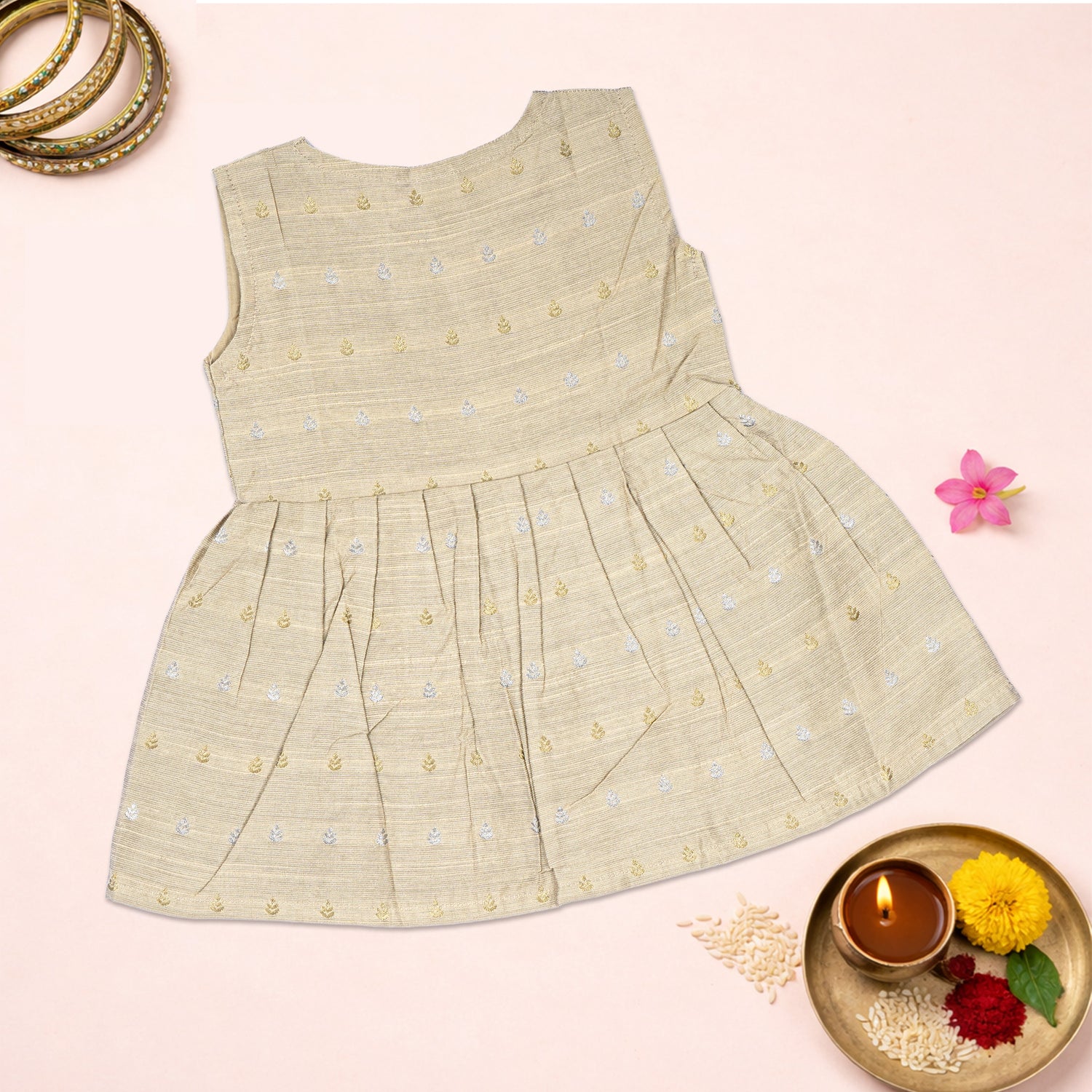 Baby girl in a premium ivory ethnic sleeveless frock by Boon Babies, featuring traditional design and delicate fabric.