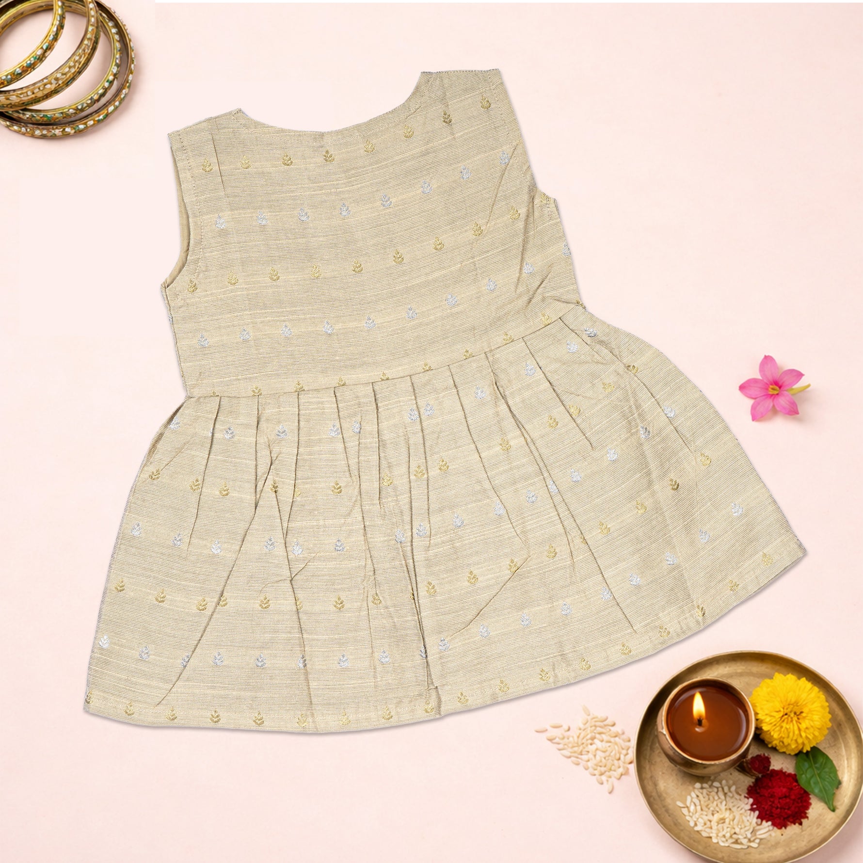 Baby girl in a premium ivory ethnic sleeveless frock by Boon Babies, featuring traditional design and delicate fabric.