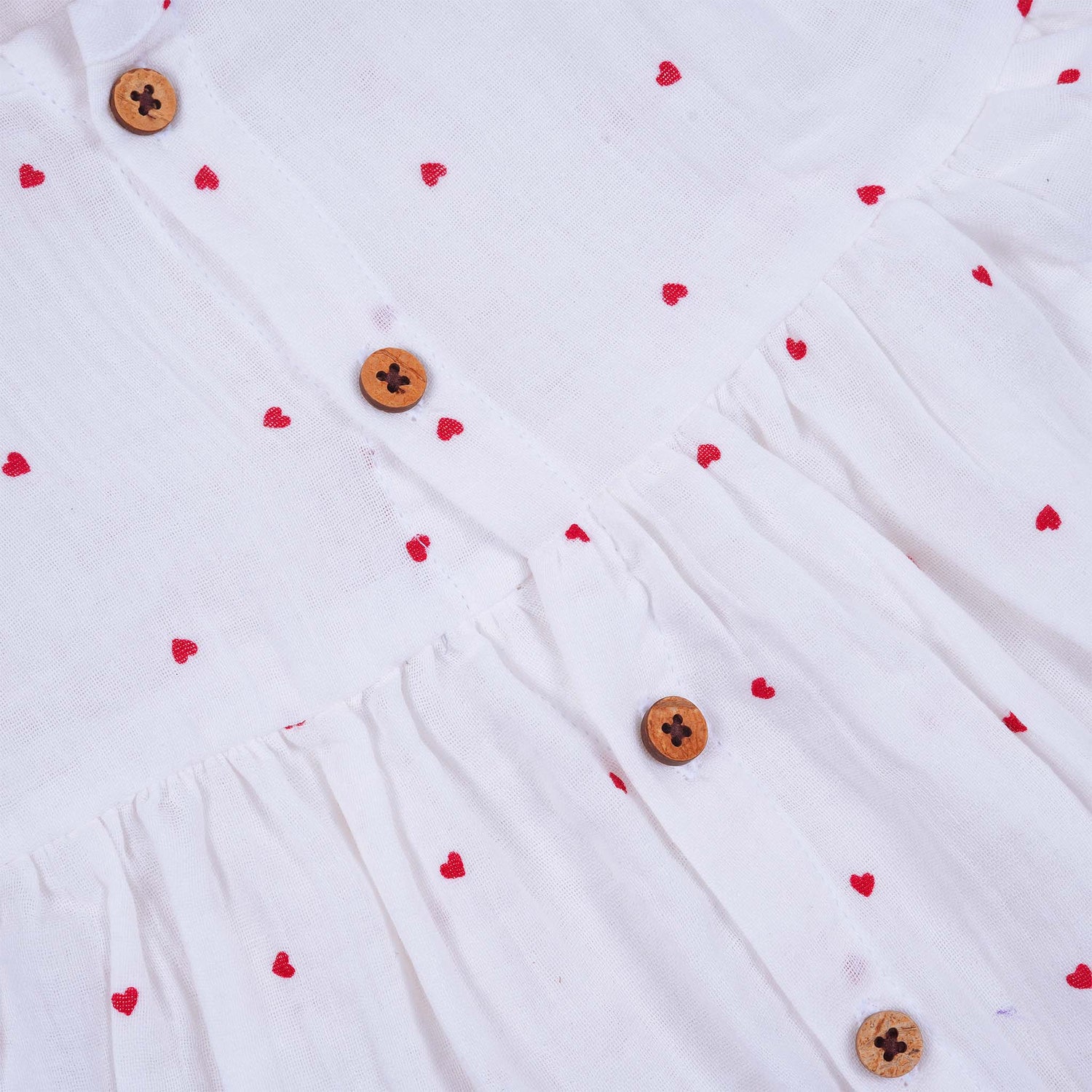 Sweet and soft muslin baby frock with red heart prints. Ages 3–18 months. Designed for comfort, perfect for everyday cuteness.