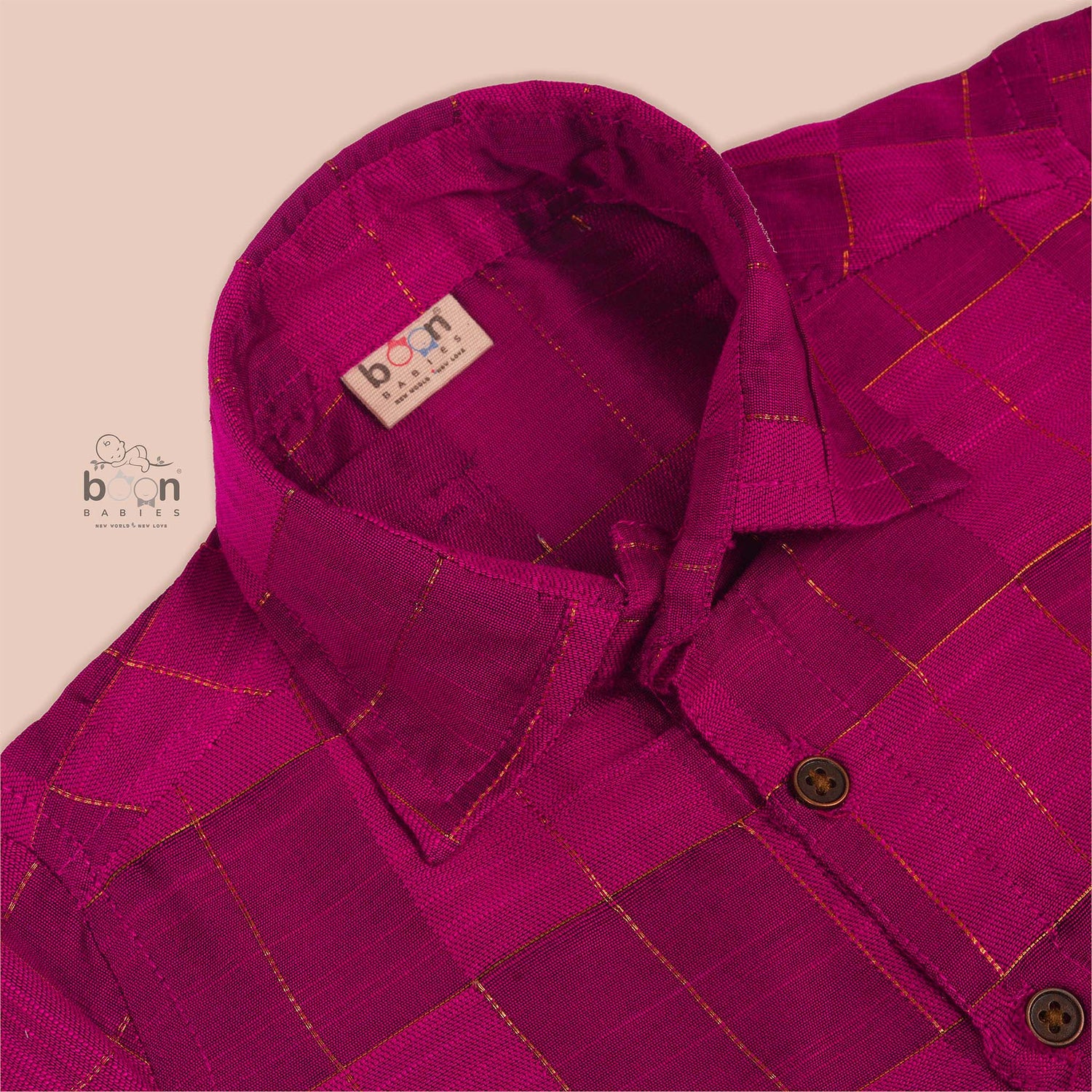 Bright magenta silk shirt with golden check patterns folded neatly – premium traditional shirt for boys by Boon Babies, Coimbatore.