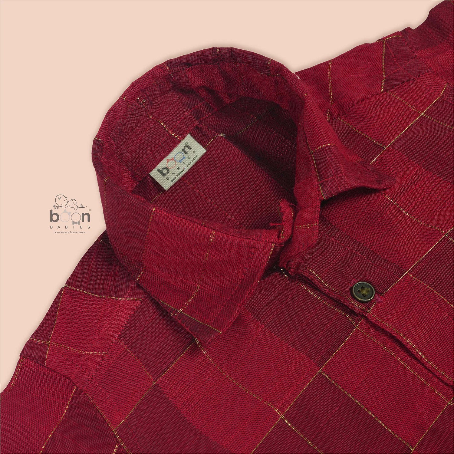 Rich red silk shirt with golden check pattern, folded neatly beside a white veshti – premium festive shirt for boys from Boon Babies, Coimbatore