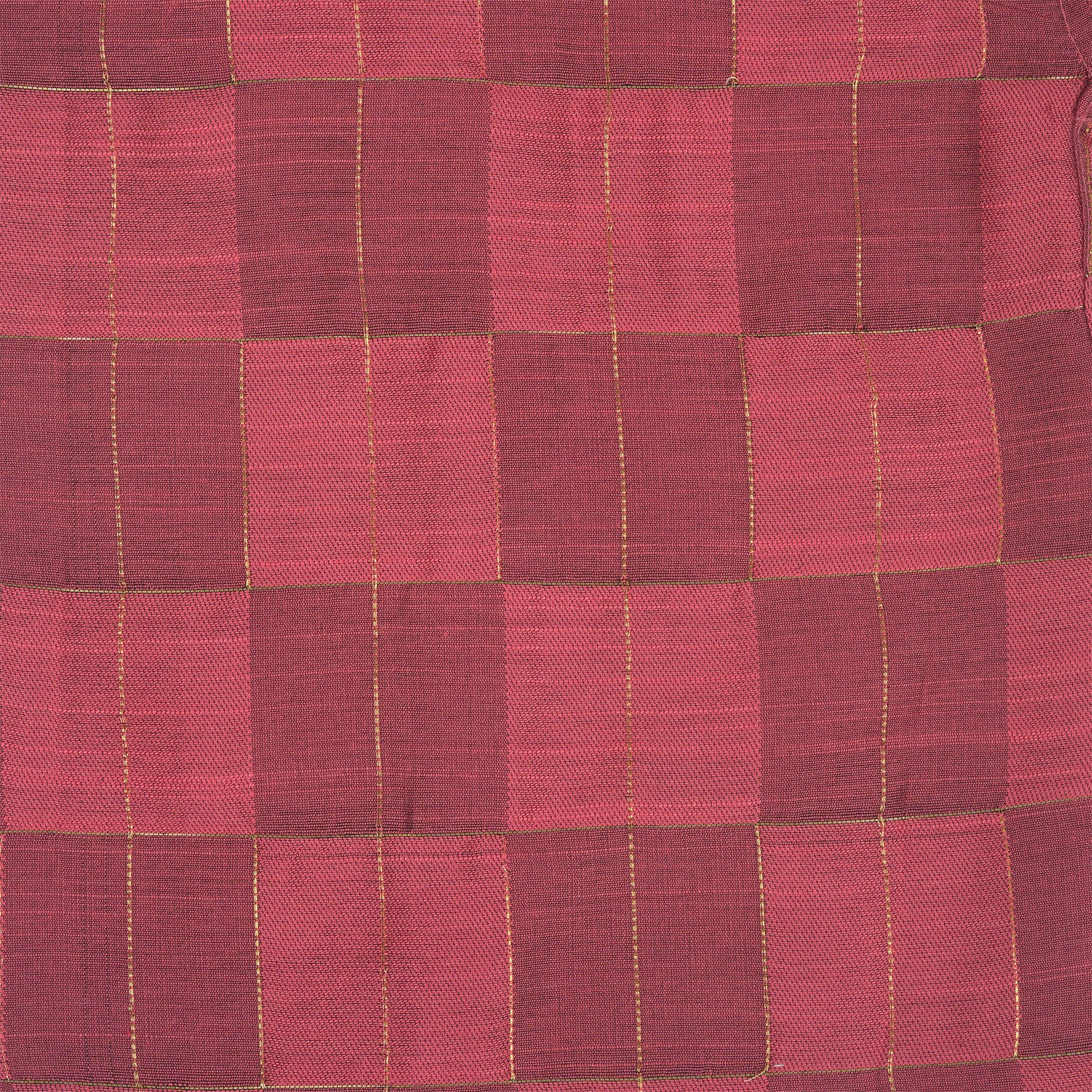 Folded rose pink silk shirt with golden grid pattern, placed beside a white veshti – boys' traditional festive wear from Boon Babies, Coimbatore.