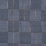 Folded slate grey silk shirt with subtle gold check design placed next to a traditional white veshti – boys’ festive ethnicwear by Boon Babies, Coimbatore.