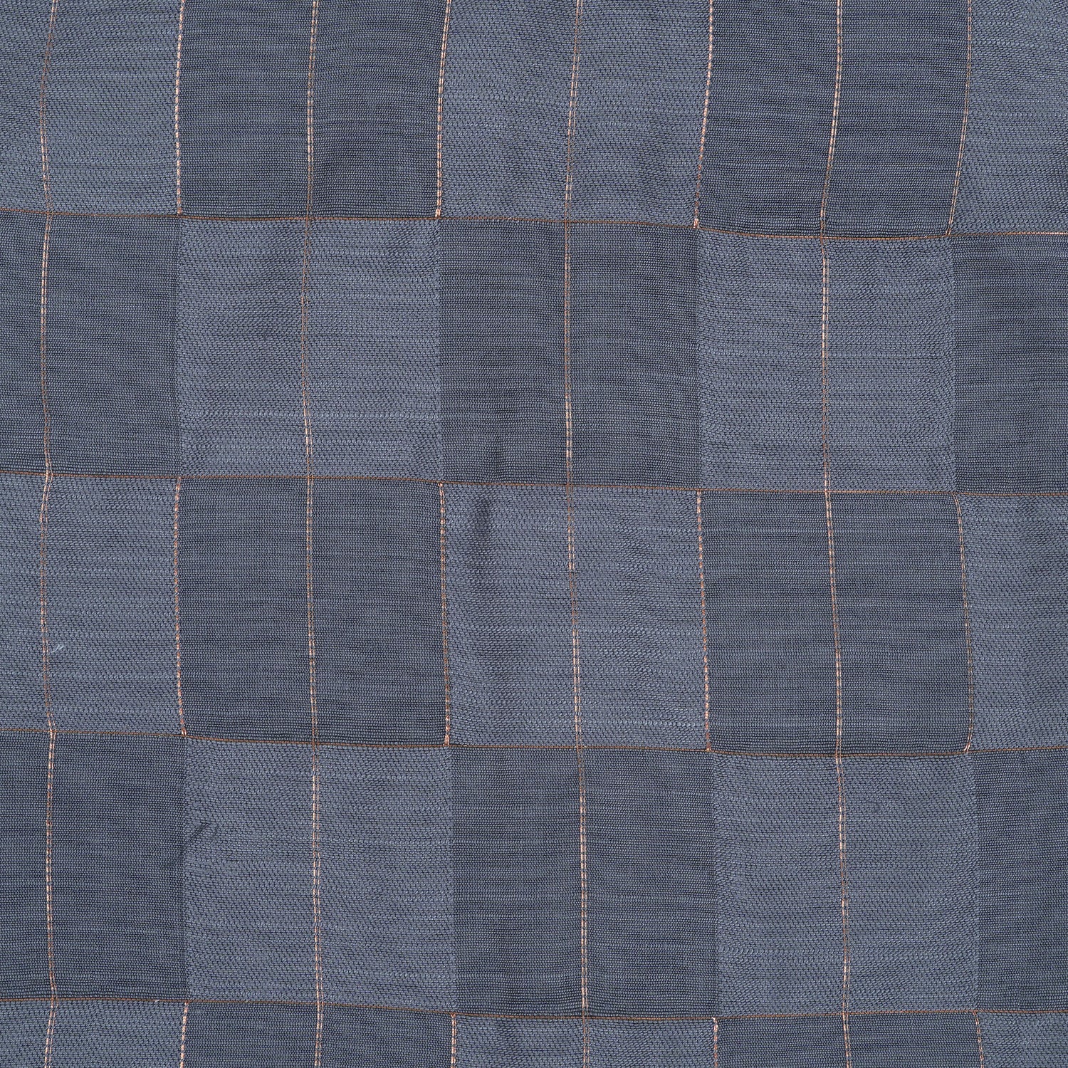 Folded slate grey silk shirt with subtle gold check design placed next to a traditional white veshti – boys’ festive ethnicwear by Boon Babies, Coimbatore.