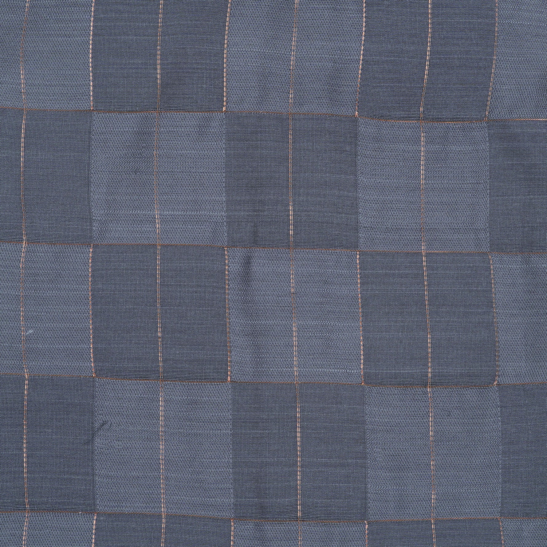 Folded slate grey silk shirt with subtle gold check design placed next to a traditional white veshti – boys’ festive ethnicwear by Boon Babies, Coimbatore.