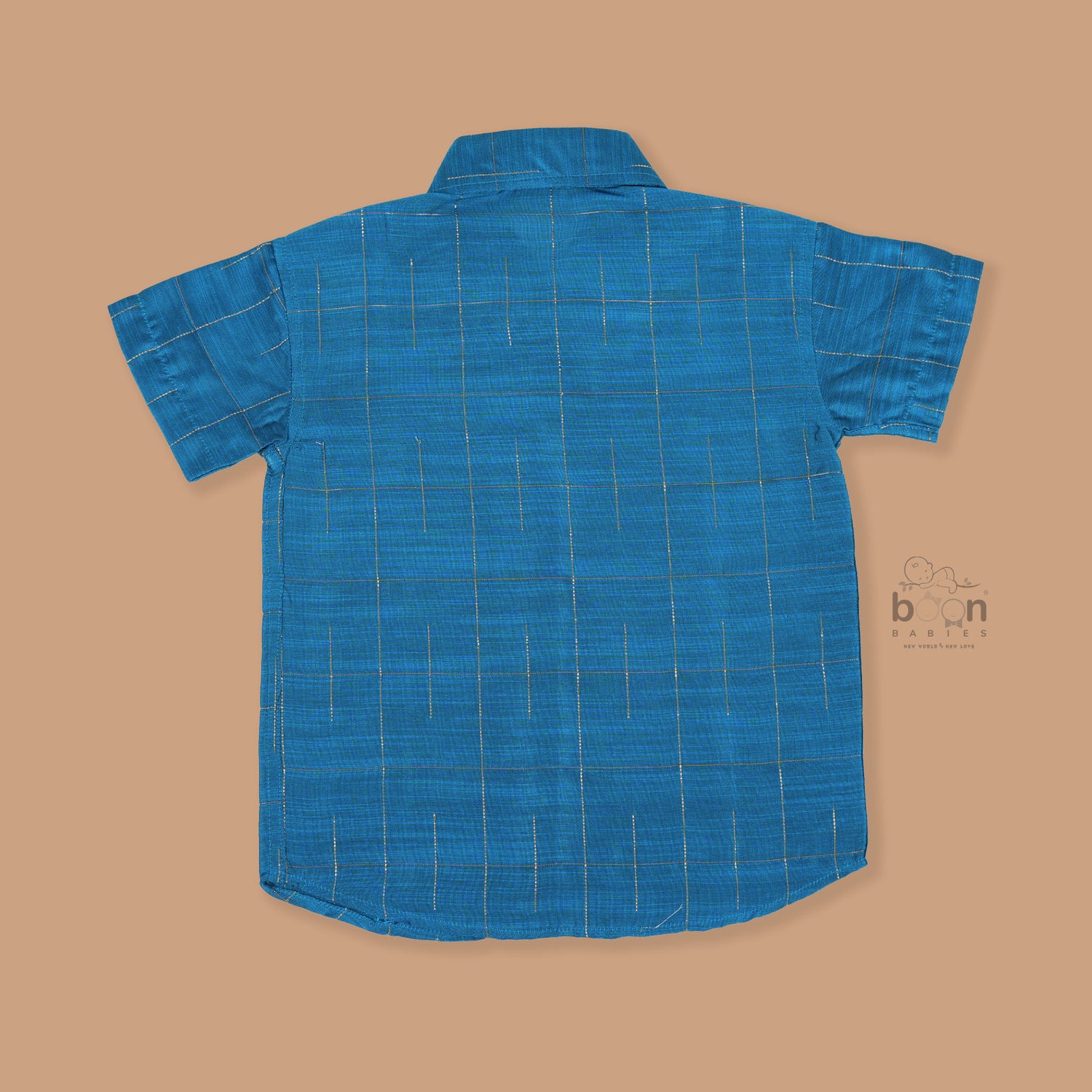 Boys festive outfit featuring a royal blue checked silk shirt and white dhoti with gold border – traditional South Indian attire by Boon Babies.
