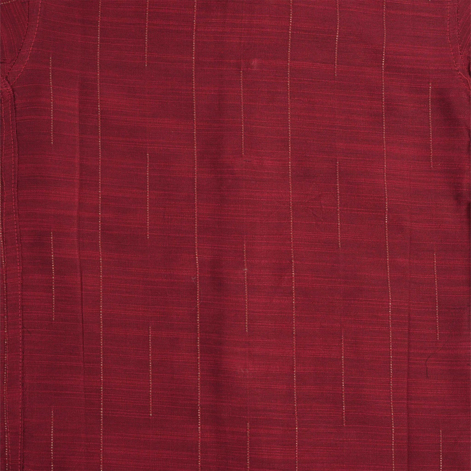 Maroon silk shirt with vertical golden lines, folded next to a traditional white veshti – boys' festive ethnic shirt by Boon Babies, Coimbatore.