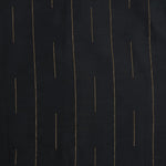 Folded black silk shirt with golden vertical lines, paired with traditional white veshti – premium ethnicwear for boys by Boon Babies, Coimbatore.