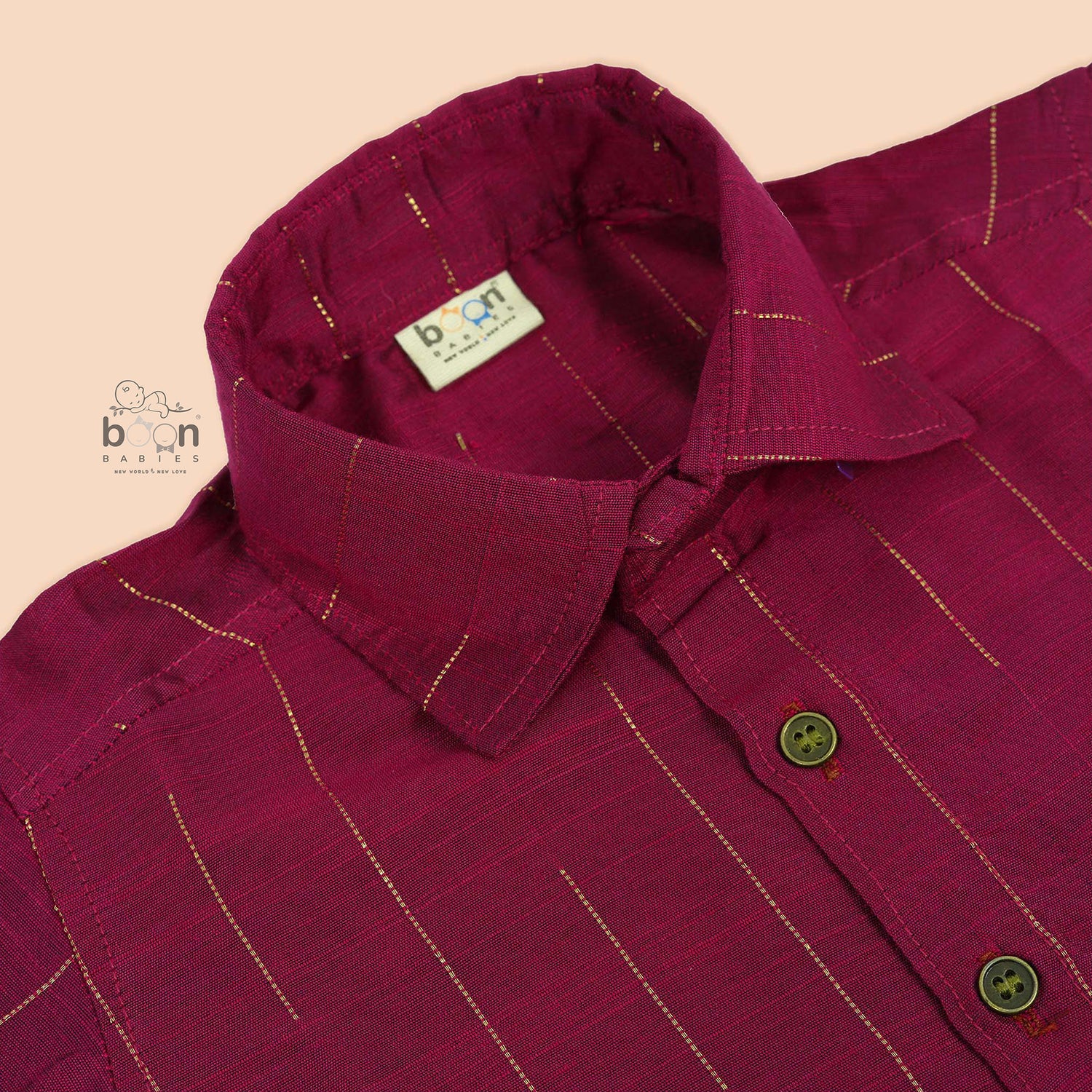 Boys magenta silk shirt neatly folded beside traditional white veshti – premium ethnicwear from Boon Babies.