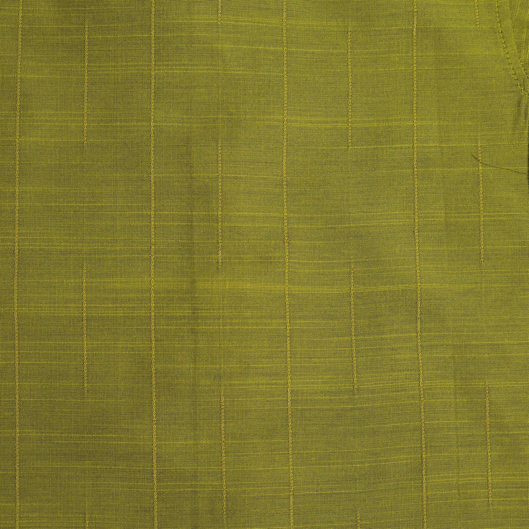 Boys lime green silk shirt with gold detailing, folded beside a white dhoti – festive kidswear set by Boon Babies.