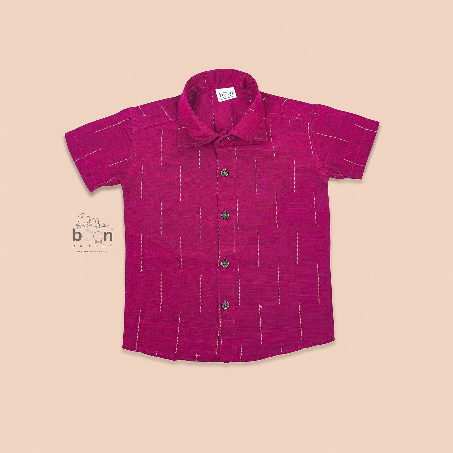 Magenta pink silk shirt for boys with gold vertical stripes, neatly folded beside a traditional white and gold dhoti – from Boon Babies ethnic wear collection.

