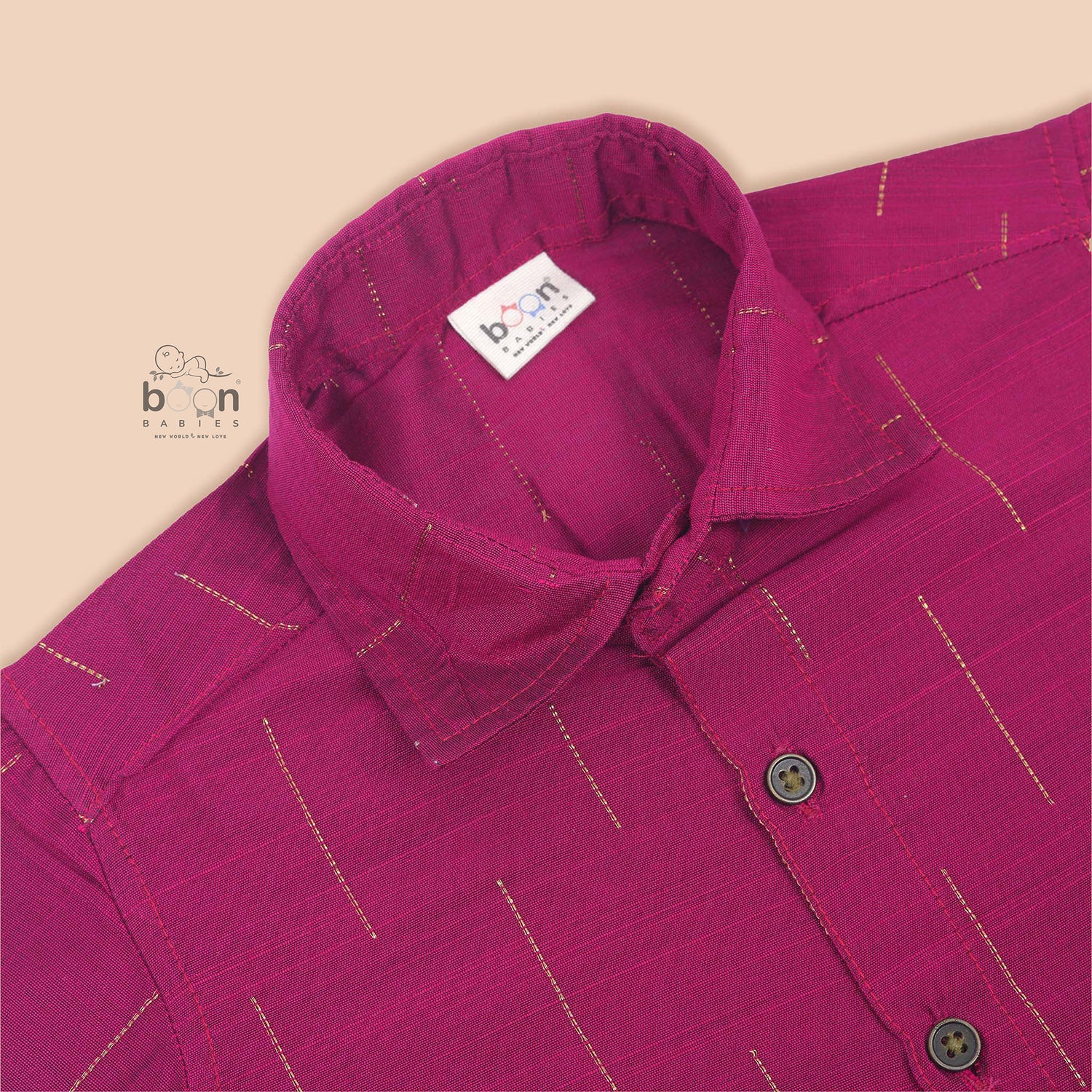 Magenta pink silk shirt for boys with gold vertical stripes, neatly folded beside a traditional white and gold dhoti – from Boon Babies ethnic wear collection.
