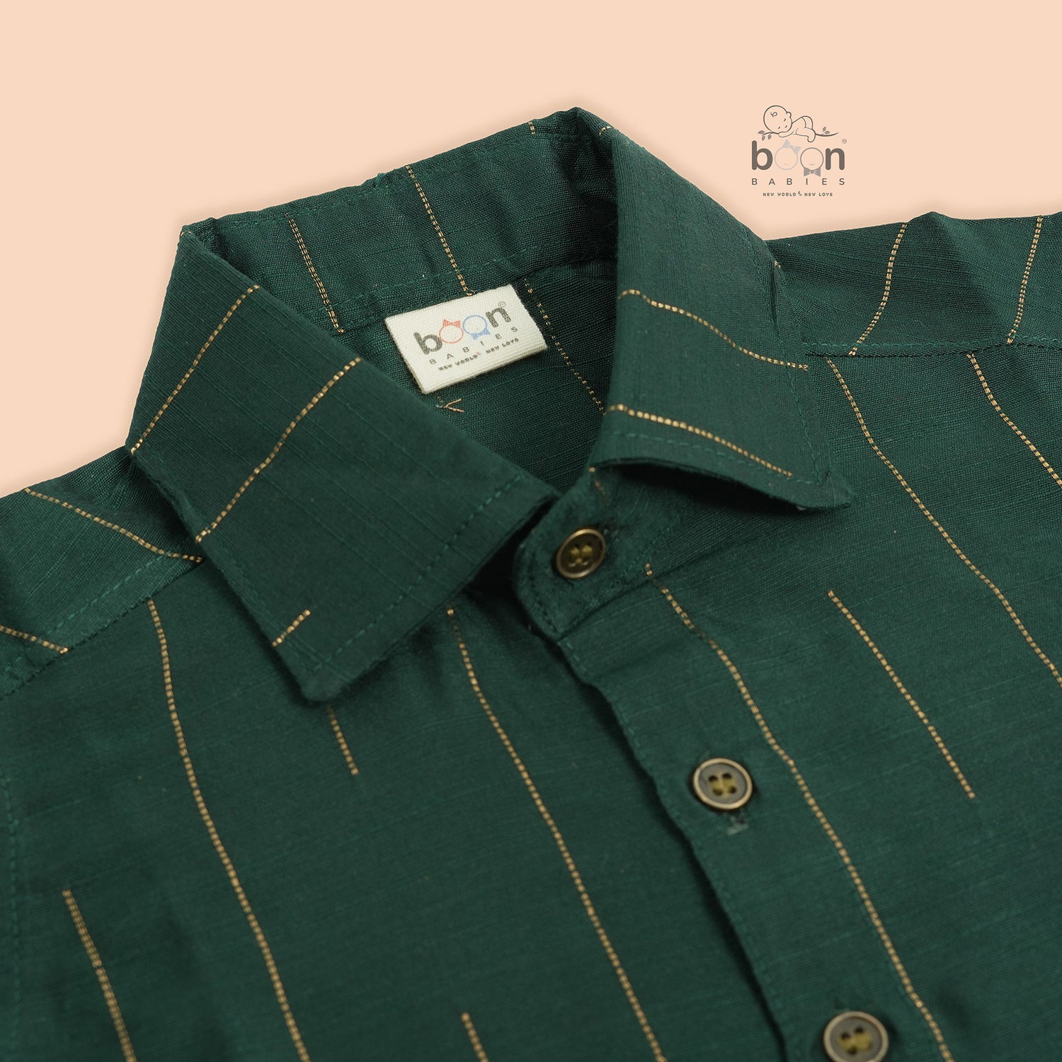 Bottle green silk shirt for boys with golden vertical threads, paired with white pattu dhoti – Boon Babies festive ethnic wear for toddlers.
