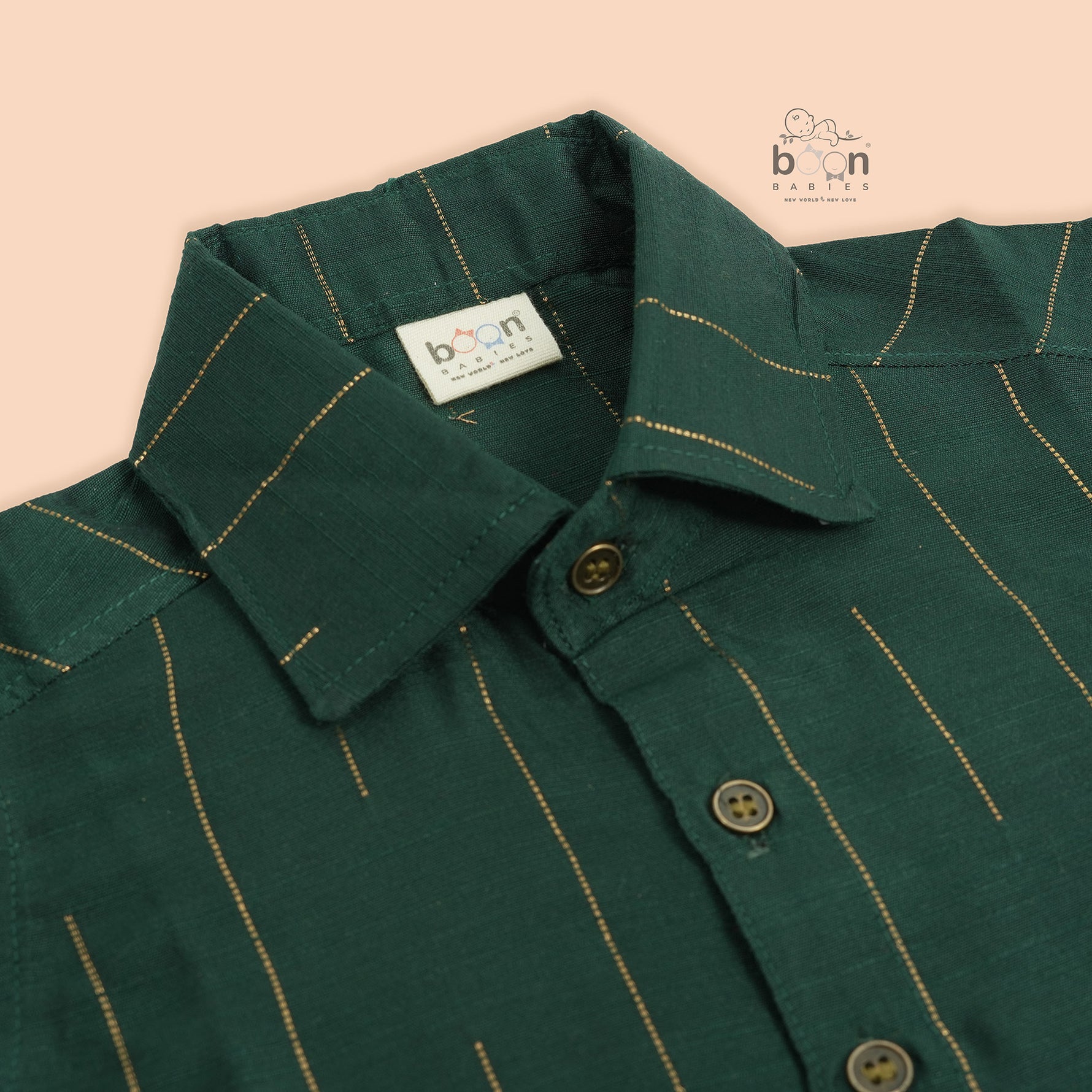 Bottle green silk shirt for boys with golden vertical threads, paired with white pattu dhoti – Boon Babies festive ethnic wear for toddlers.
