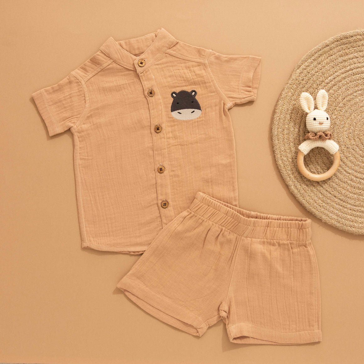 Camel beige boys muslin shirt and shorts set with hippo patch embroidery, Chinese collar, and wooden buttons – breathable summer outfit by Boon Babies.
