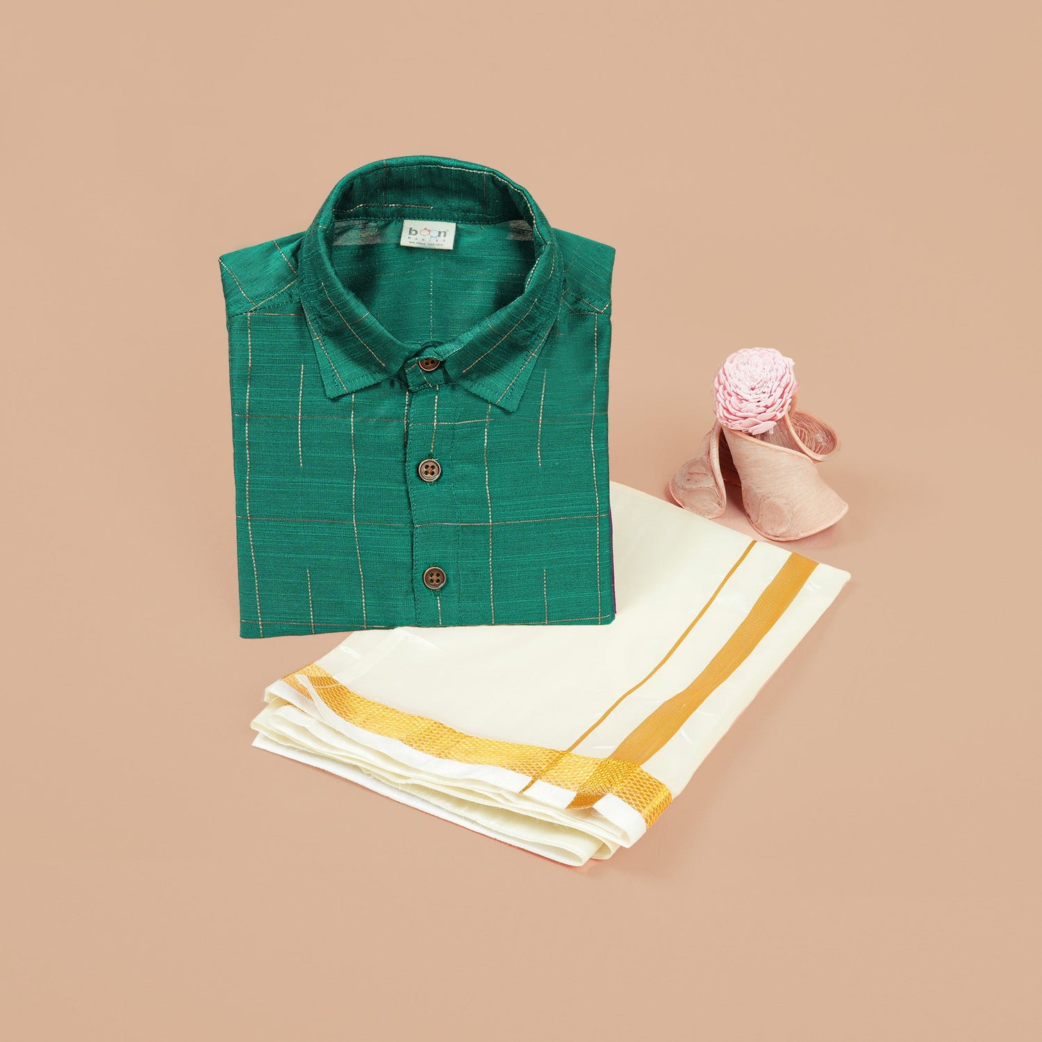 Green silk checked shirt with white dhoti featuring golden border – traditional South Indian boys ethnic wear set by Boon Babies.
