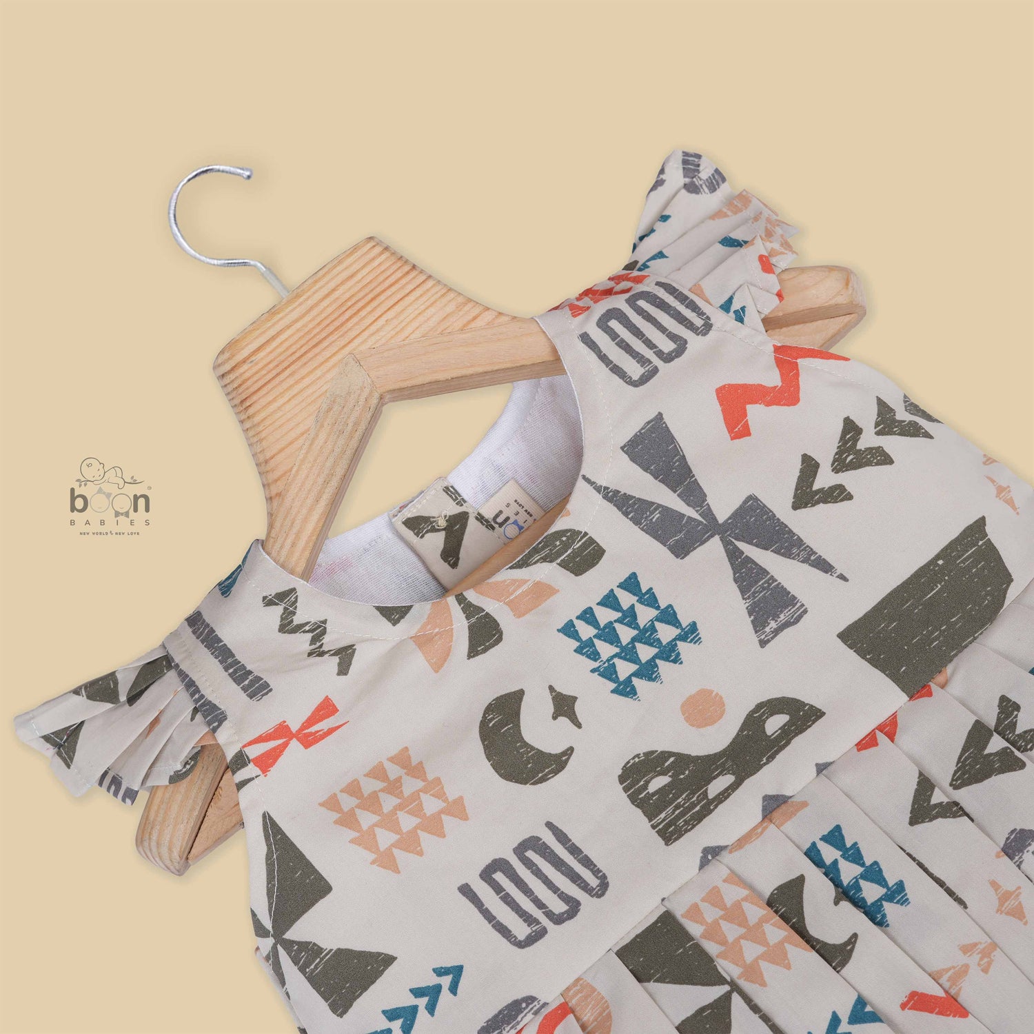 Soft cotton frock for girls featuring multicolor geometric prints and flutter sleeves. Available in sizes 6 months to 5 years. Made in Coimbatore.
