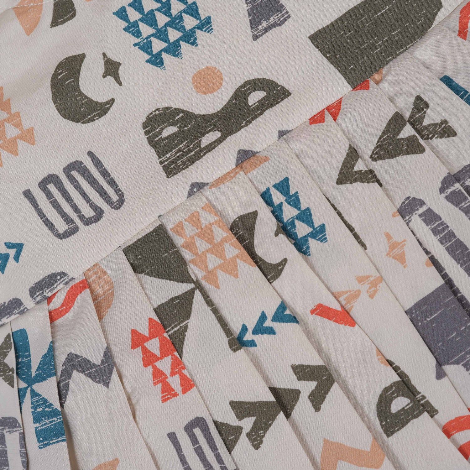 Soft cotton frock for girls featuring multicolor geometric prints and flutter sleeves. Available in sizes 6 months to 5 years. Made in Coimbatore.
