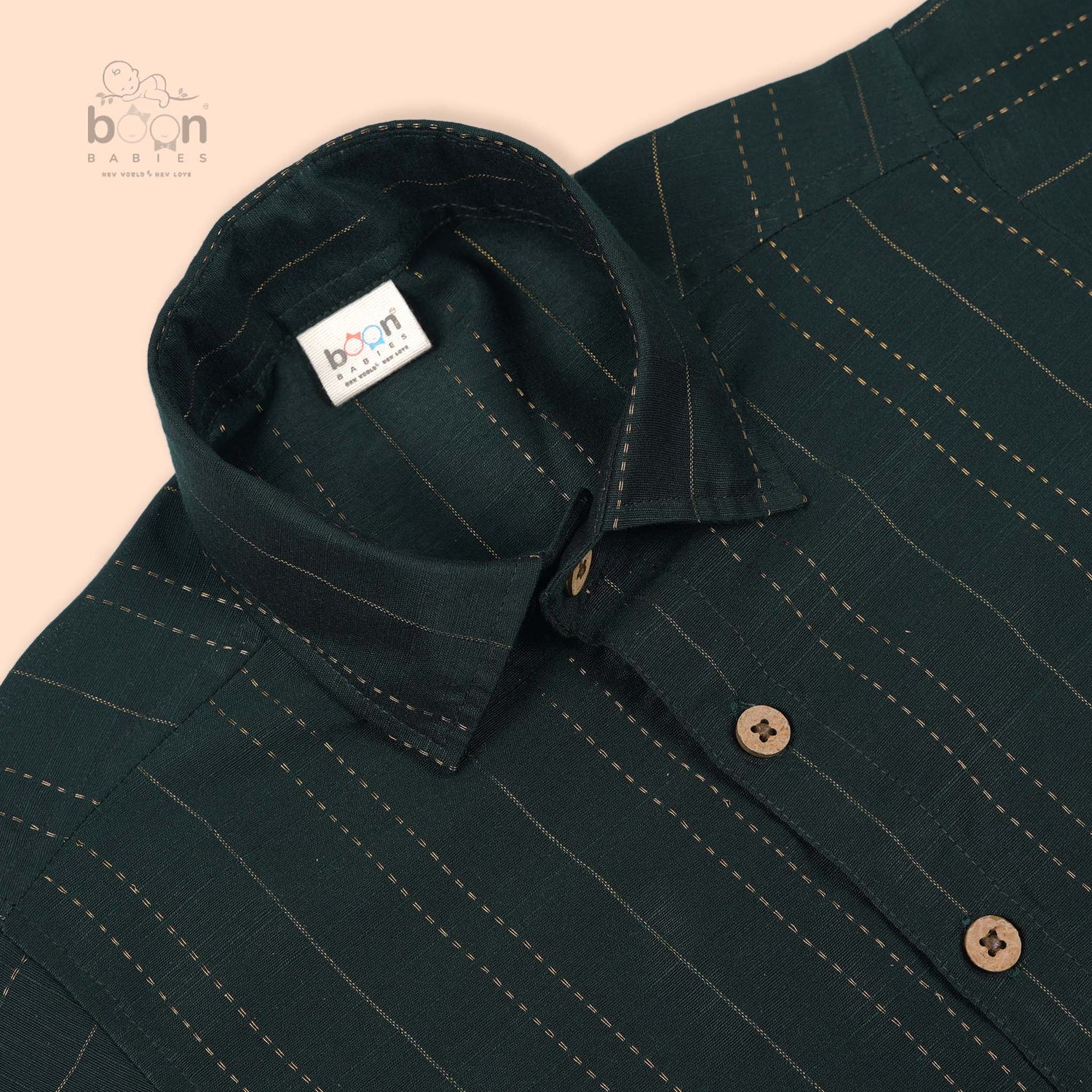 Dark green silk ethnic shirt for boys aged 12 months to 5 years, with golden vertical stripe detailing and wooden buttons – from Boon Babies’ festive wear range.