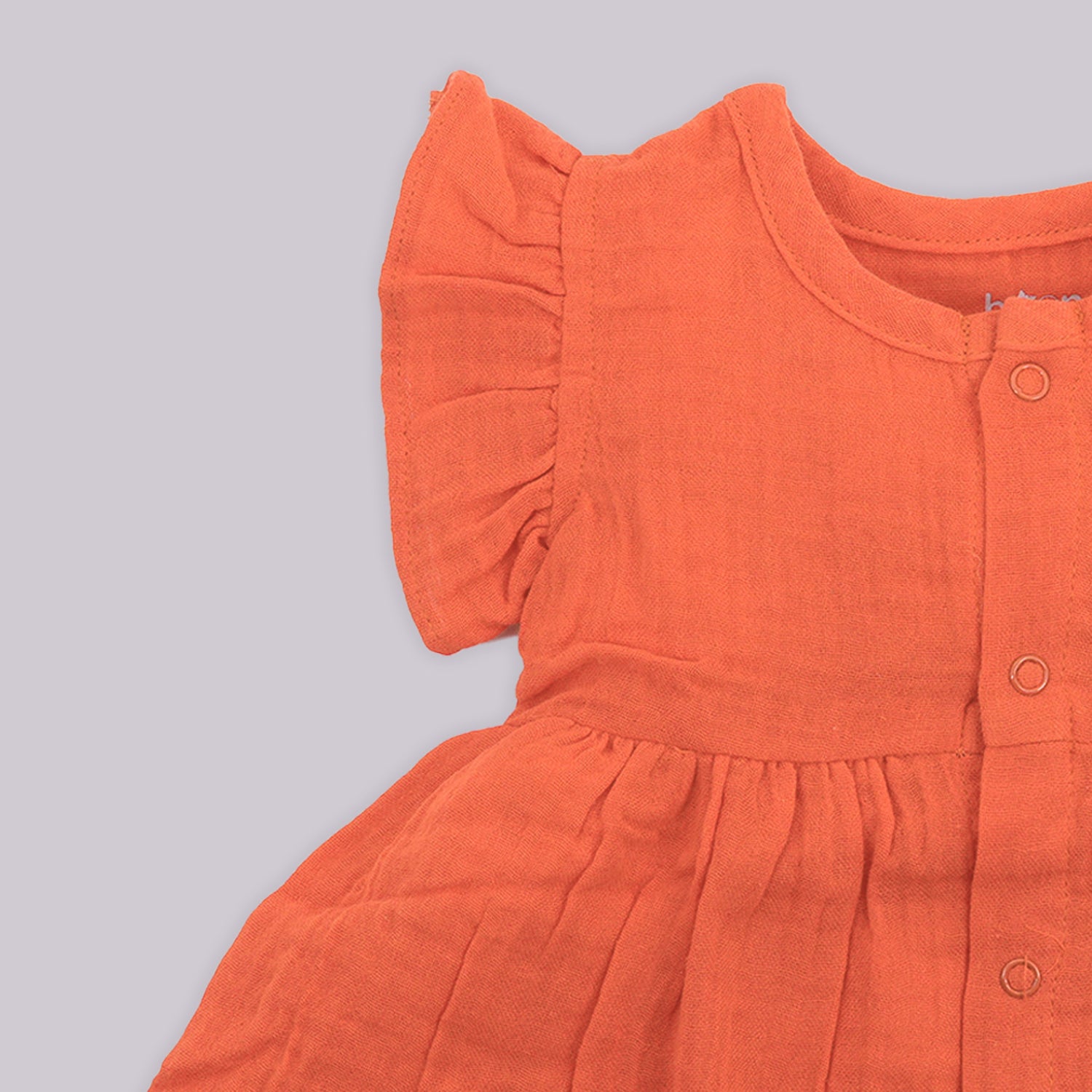 Solid rust orange crinkled muslin frill frock for baby girls.