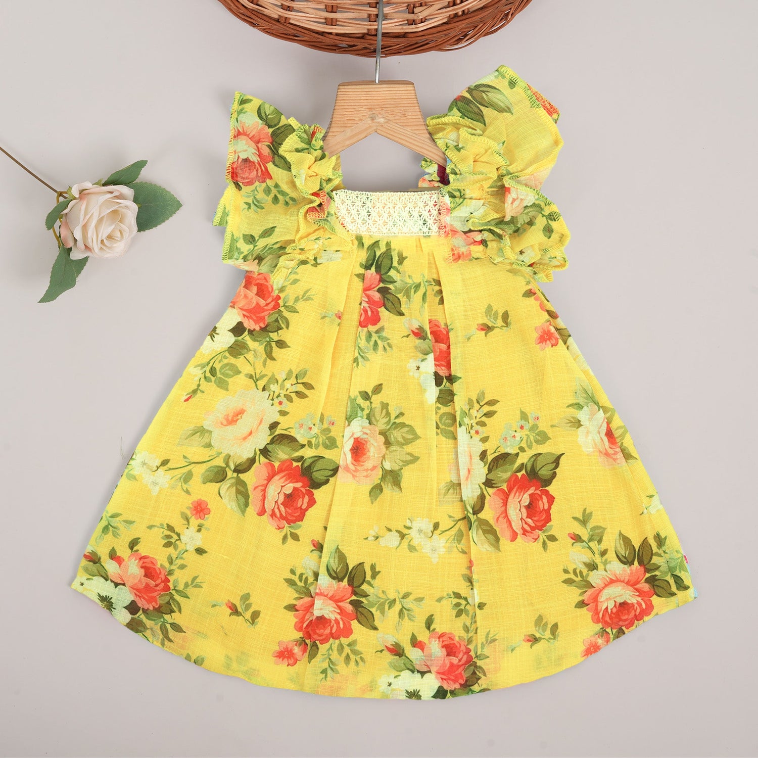 Cheerful yellow floral frock in soft linen with frill sleeves. Ages 6 months to 4 years. Summer-perfect wear for baby girls.
