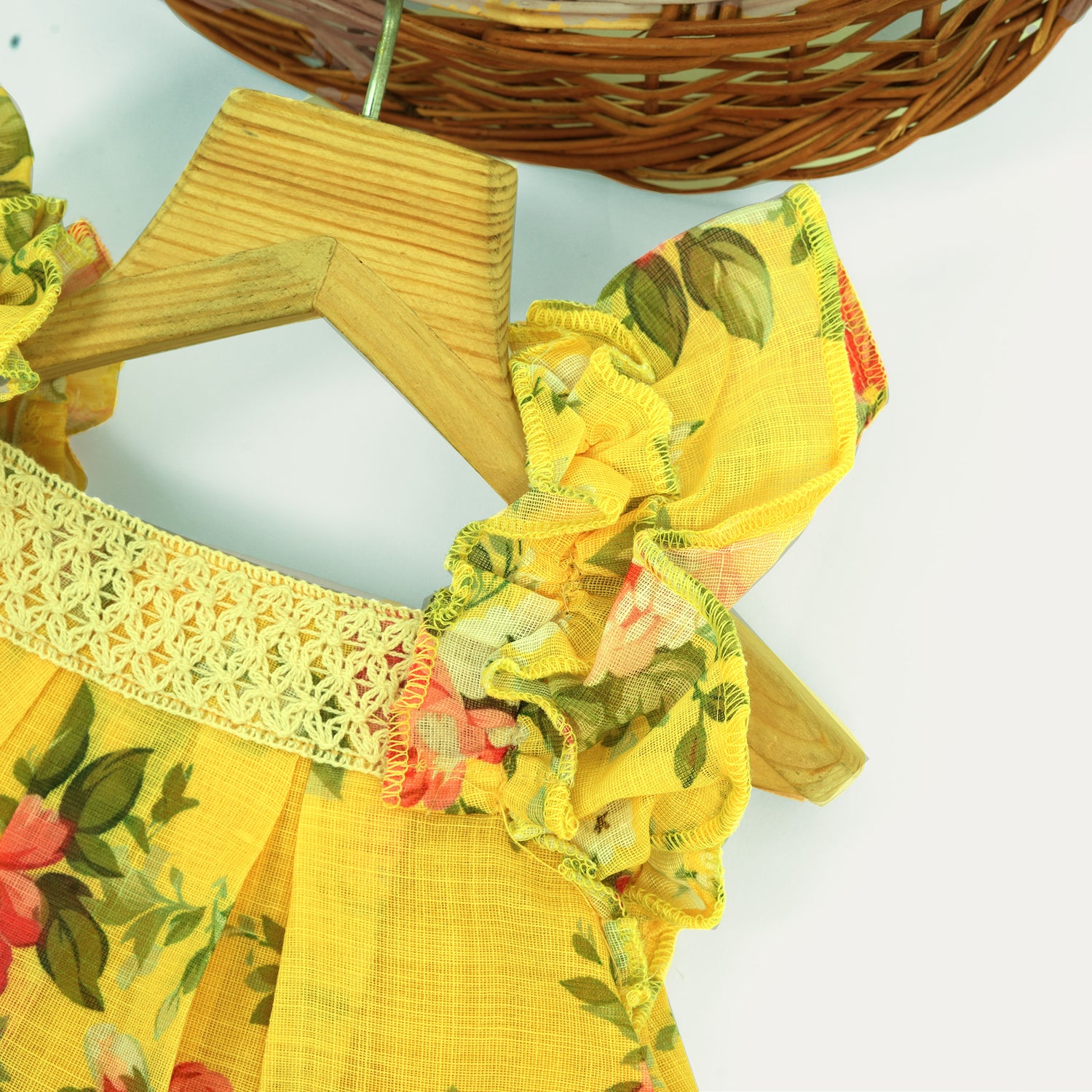 Cheerful yellow floral frock in soft linen with frill sleeves. Ages 6 months to 4 years. Summer-perfect wear for baby girls.
