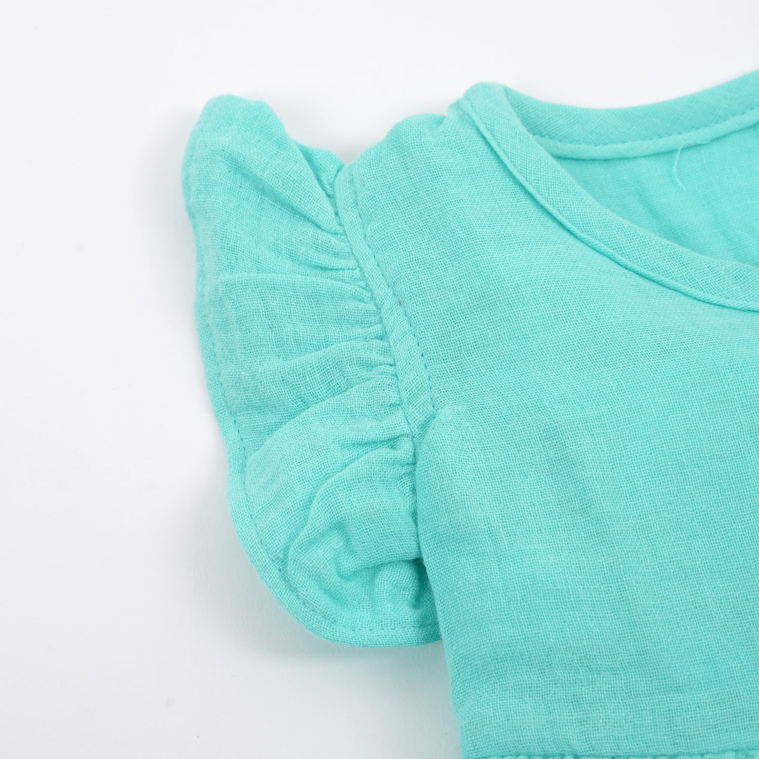 Baby girl mint green crinkled muslin frill frock from Boon Babies, featuring a soft solid design with adorable frills.