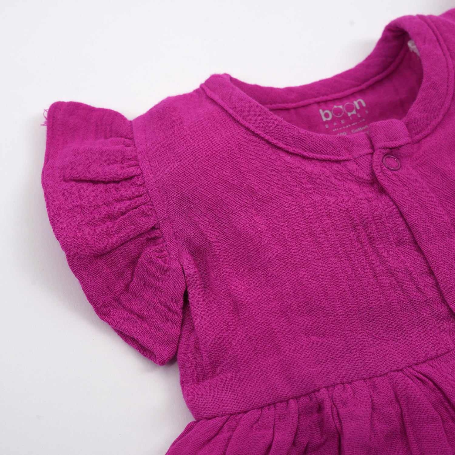 Solid magenta crinkled muslin frill frock for baby girls.