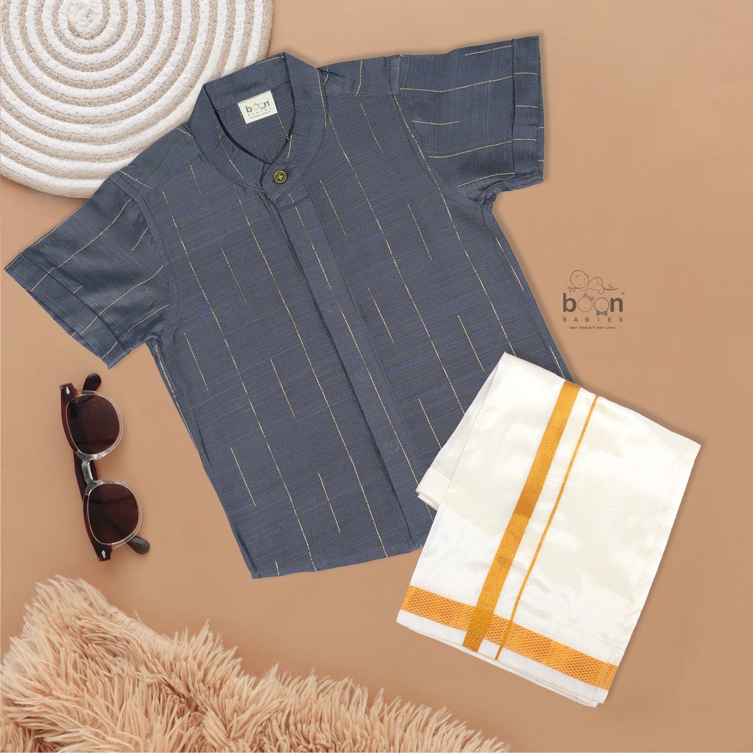 Boys ethnic silk shirt in navy with checked pattern paired with white and gold bordered dhoti, displayed flatlay style – festive wear from Boon Babies.
