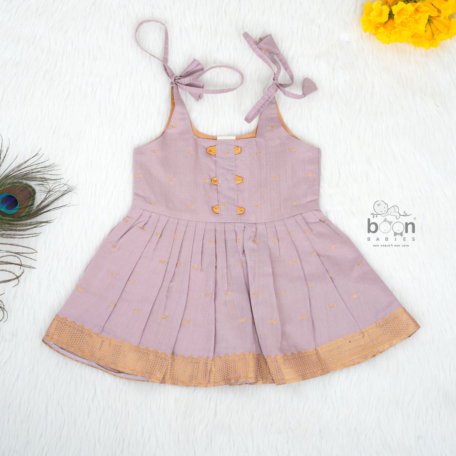 Elegant mauve silk knot frock with zari border for baby girls (0–12 months). Festive & comfortable – perfect for Onam celebrations.

