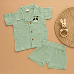Mint green boys’ shirt and shorts co-ord set in crinkled muslin with panda embroidery and wooden buttons – from Boon Babies kidswear in Coimbatore.
