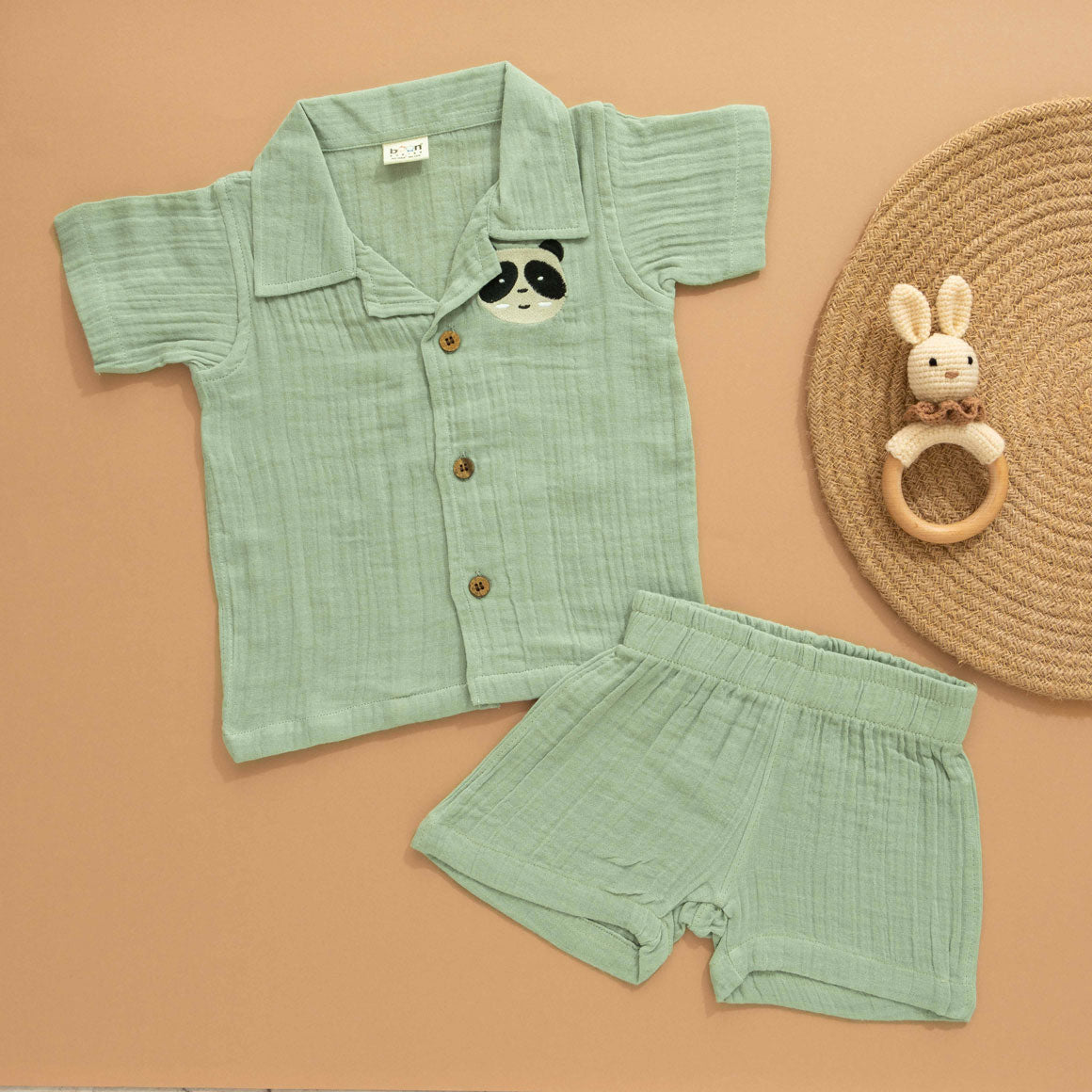 Mint green boys’ shirt and shorts co-ord set in crinkled muslin with panda embroidery and wooden buttons – from Boon Babies kidswear in Coimbatore.
