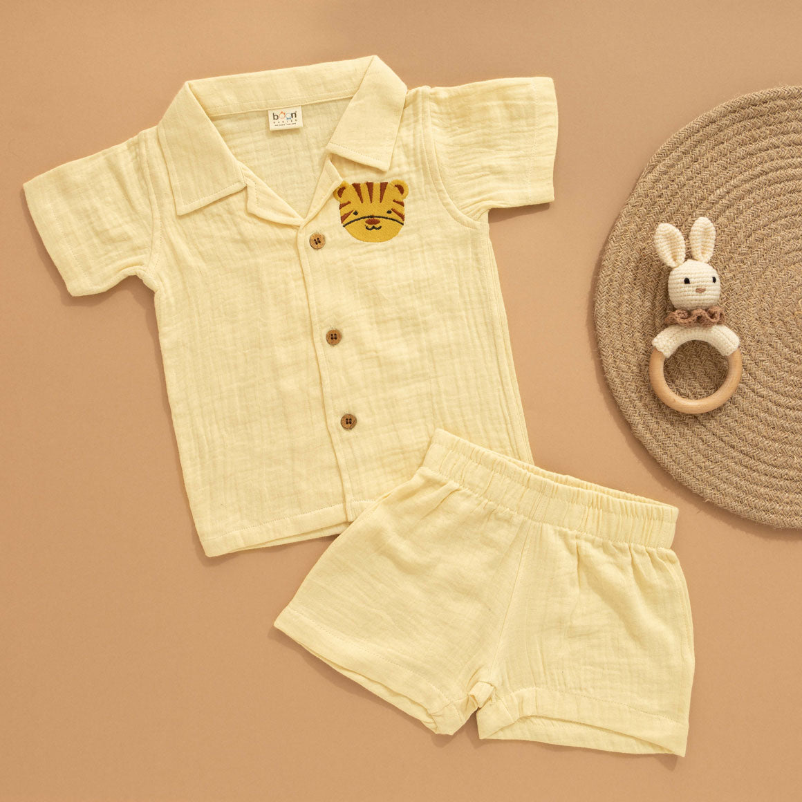Light yellow boys shirt and shorts set in crinkled muslin with tiger patch and wooden buttons – breathable summer co-ord from Boon Babies.
