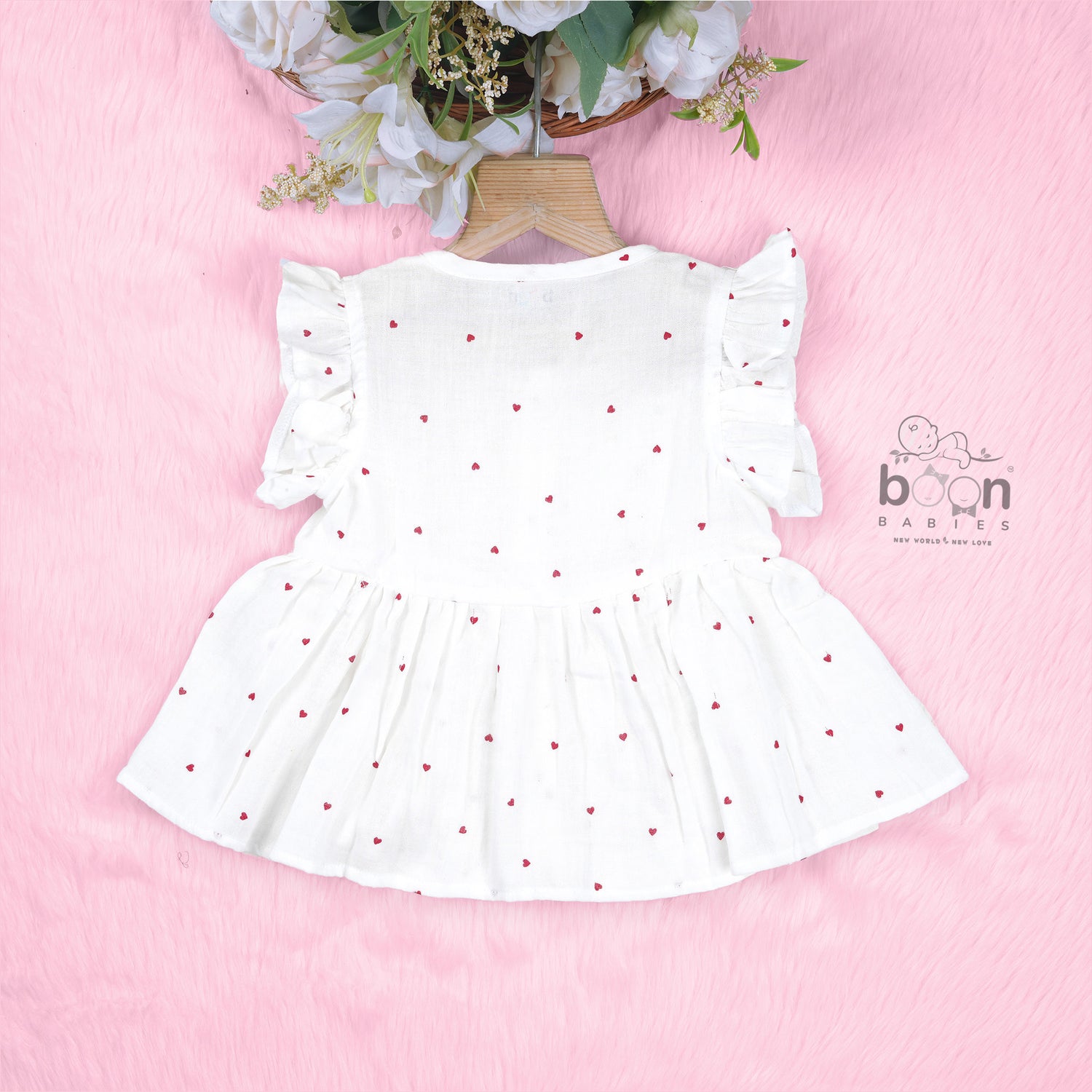 Sweet and soft muslin baby frock with red heart prints. Ages 3–18 months. Designed for comfort, perfect for everyday cuteness.