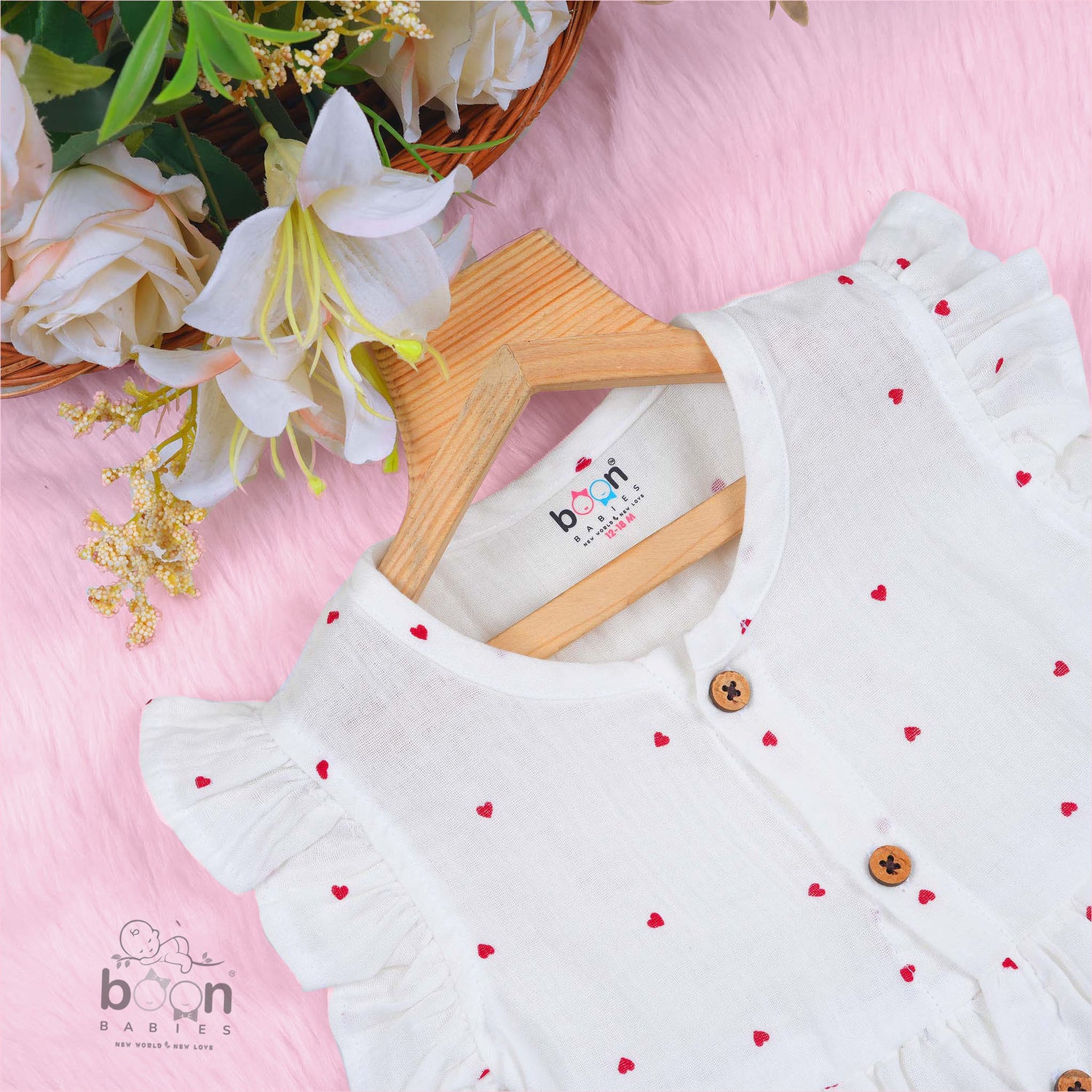 Sweet and soft muslin baby frock with red heart prints. Ages 3–18 months. Designed for comfort, perfect for everyday cuteness.