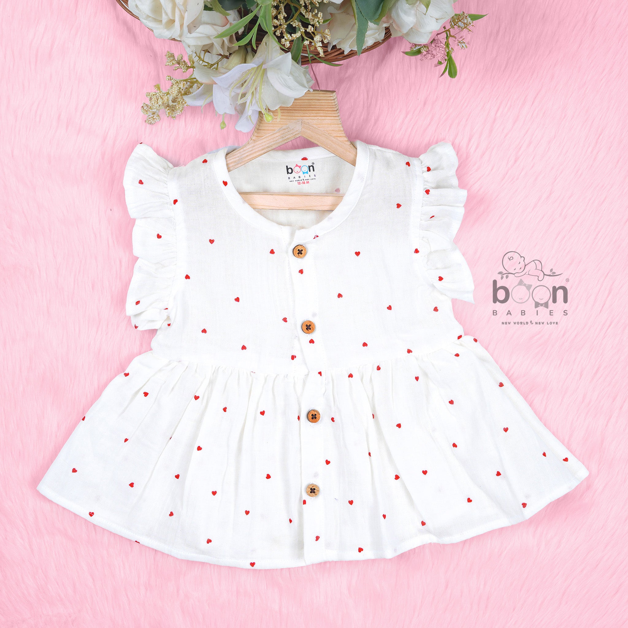 Pink crinkled muslin frill frock for baby girls by Boon Babies, featuring a soft solid design with cute frill details.