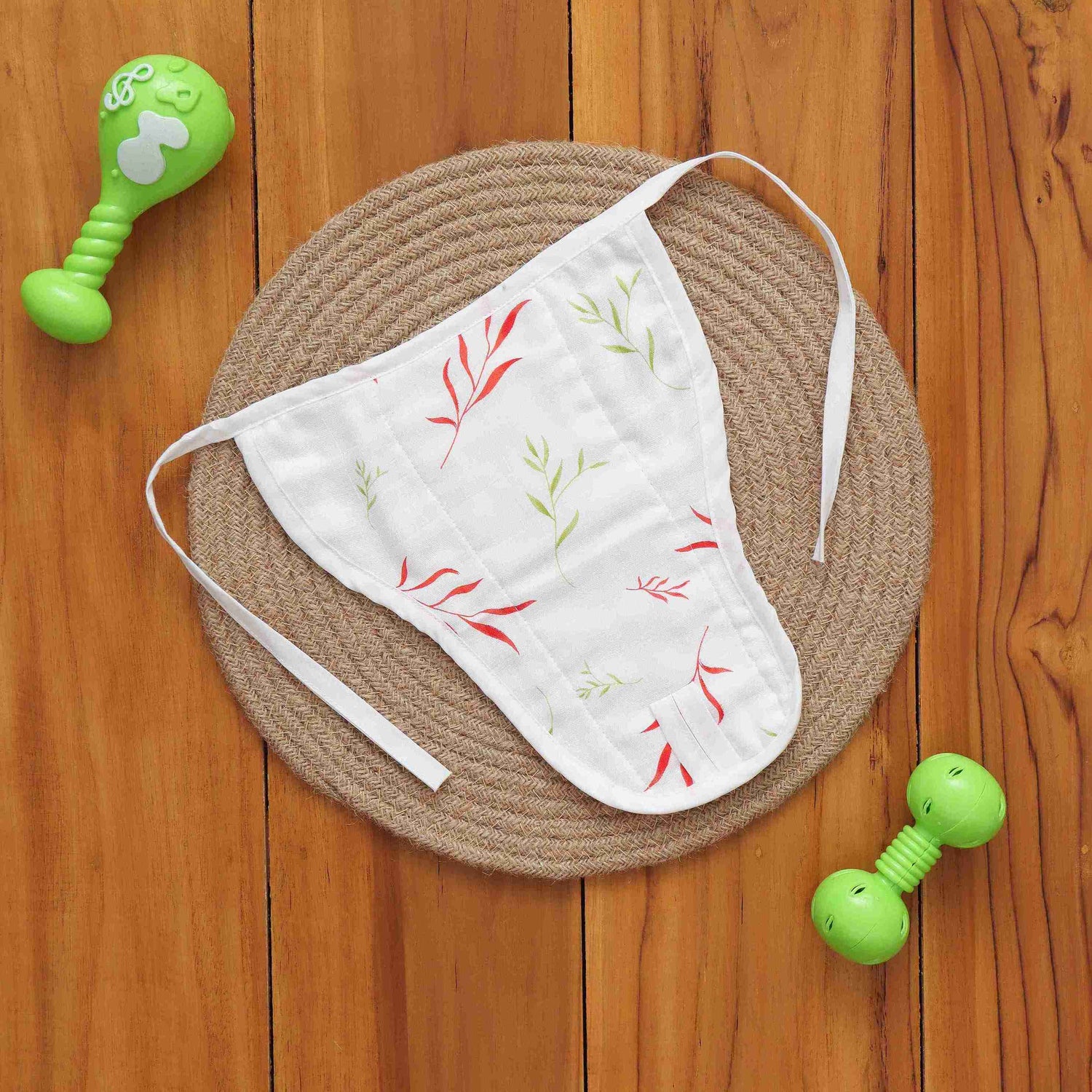 Soft muslin nappy with red & green leaf print. 0–3 months. Lightweight, reusable, and baby-friendly with tie closure.
