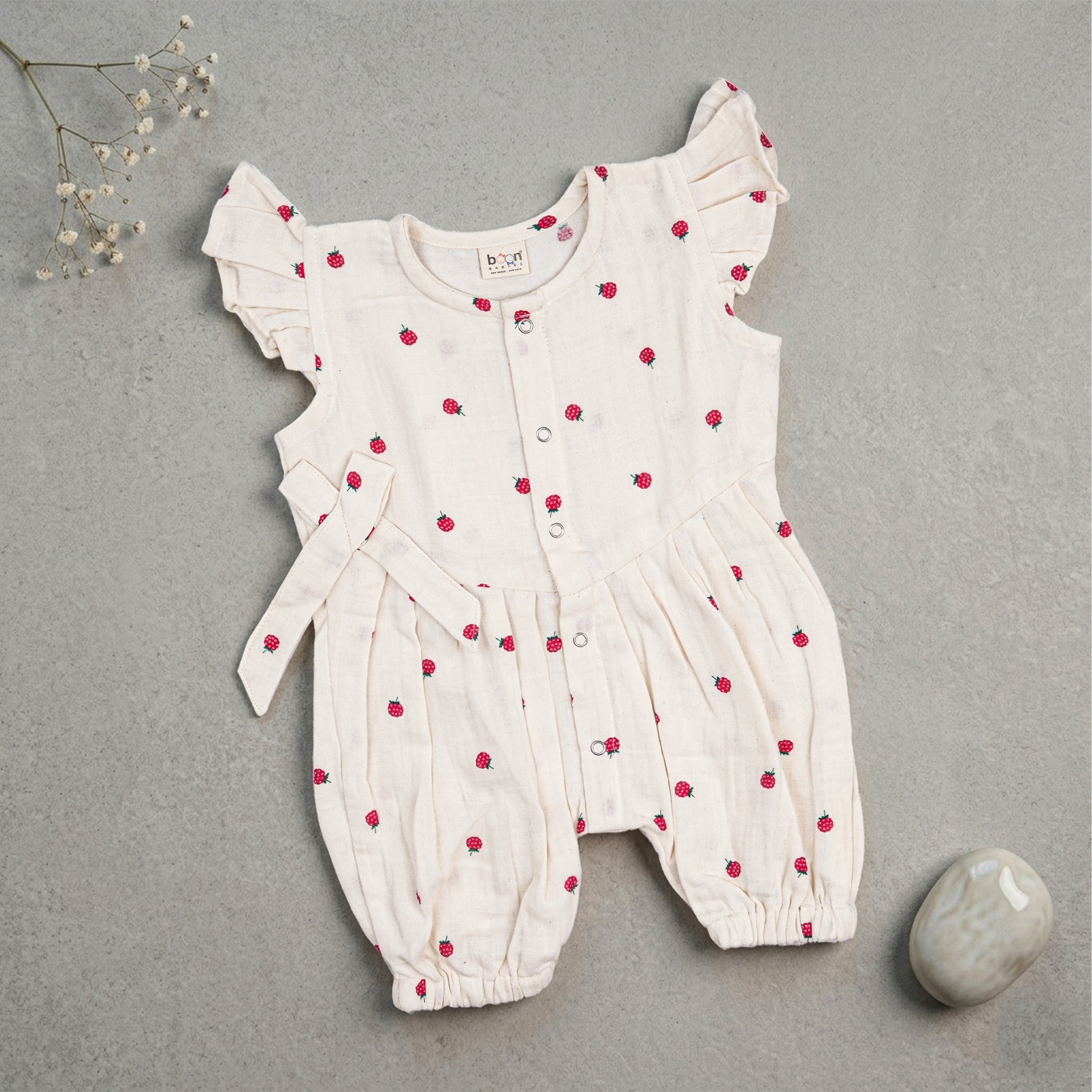 Baby girl baby romper with printed muslin fabric and frill sleeves by Booon Babies, featuring adorable design and soft material.