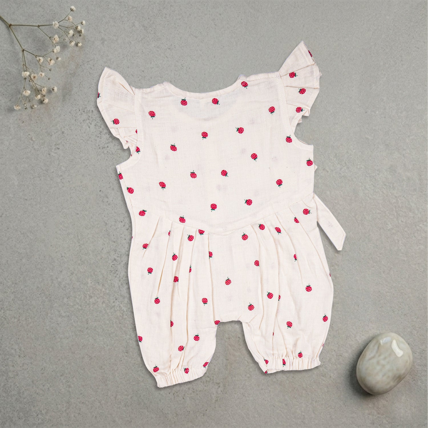 Baby girl romper with printed muslin fabric and frill sleeves, stylish and comfortable for warm weather by Boon Babies.