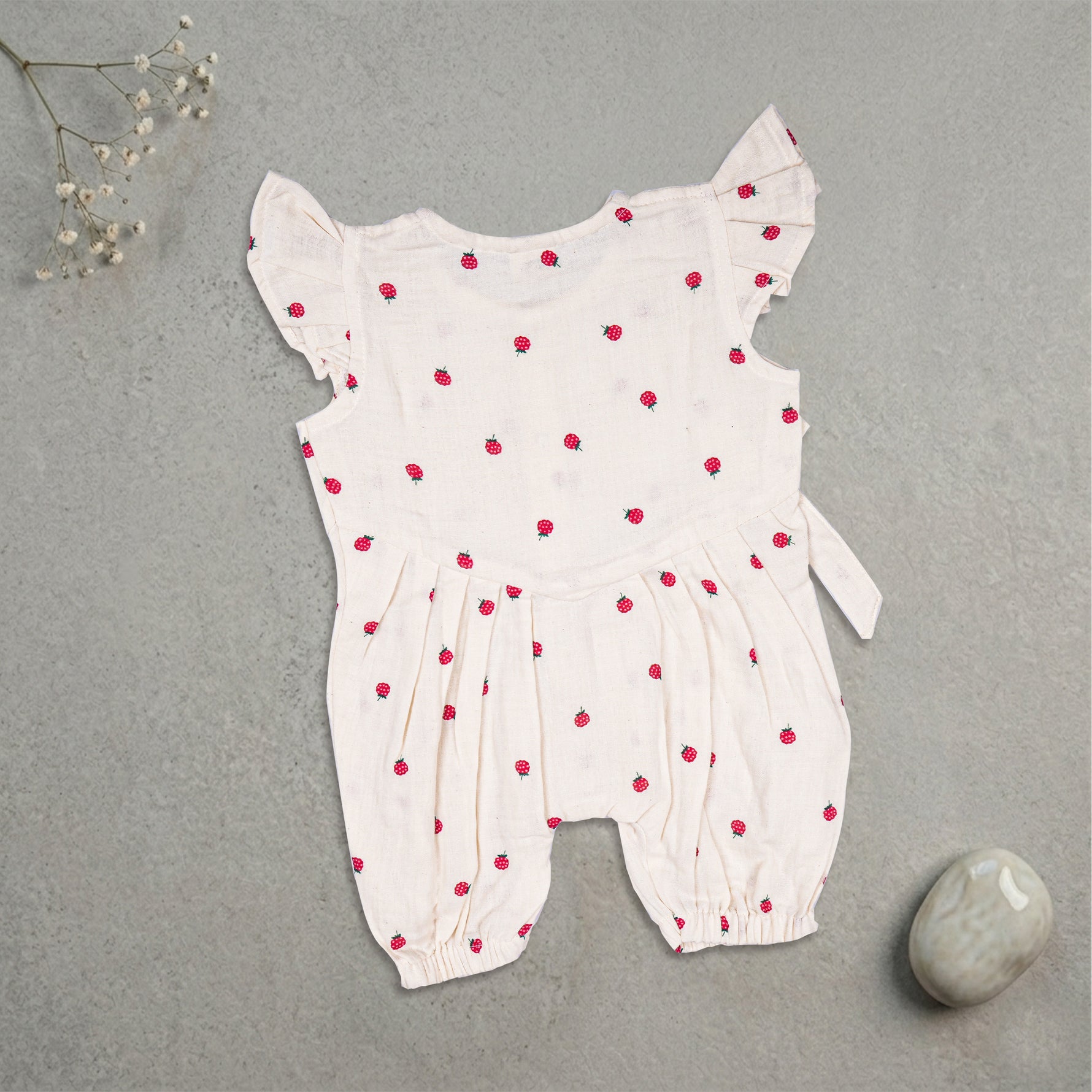 Baby girl romper with printed muslin fabric and frill sleeves, stylish and comfortable for warm weather by Boon Babies.