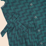 Baby girl in green muslin printed romper with frill sleeves by Booon Babies, showing the adorable, lightweight baby romper.