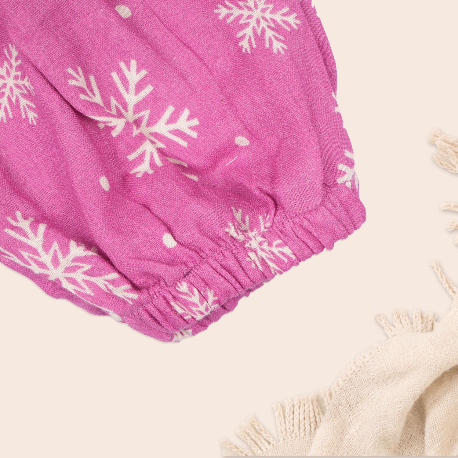 Baby girl baby romper with pink muslin fabric, printed design, and frill sleeves by Booon Babies.