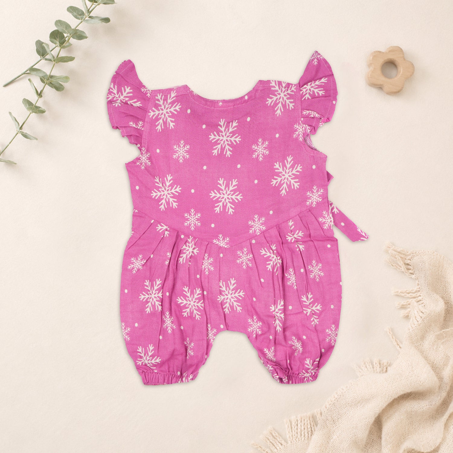 Baby girl baby romper in pink with muslin fabric, printed design and frill sleeves, by Booon Babies.